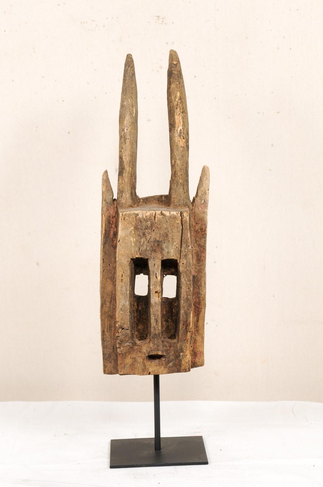 A Dogon Mali Dama ceremonial dance mask from the early to mid 20th century. This Dogon tribal wooden ceremonial dance mask originates from Mali, West Africa. The mask is carved to represent an antelope. The antelope or 