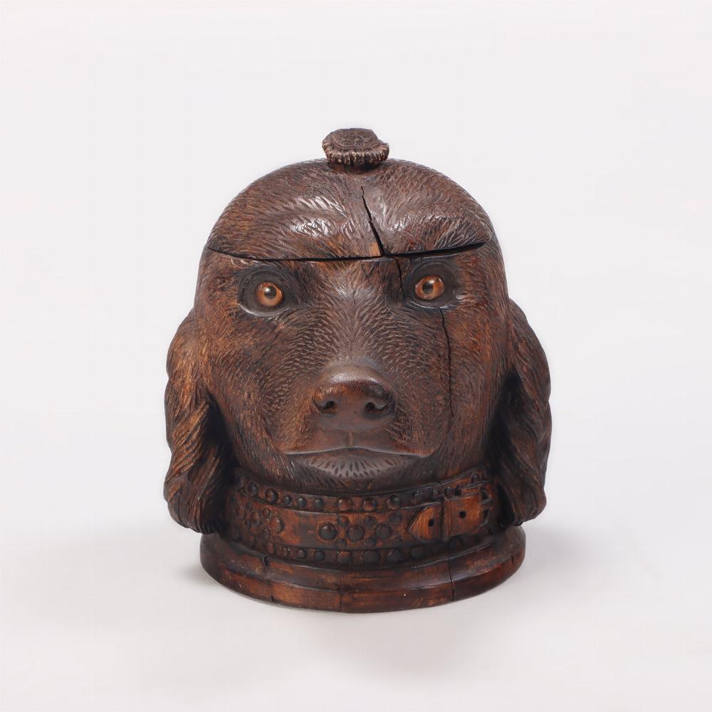 A whimsical antique Black Forest hand carved wood figural tobacco humidor box. Modeled as a dog with removable head and glass inset eyes. 