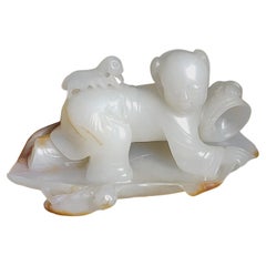 A White and Russet Jade Carving of a Boy Catching Crickets, Qing Dynasty