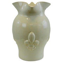 A white glazed ceramic water pitcher with a fleur-de-lys decorations France
