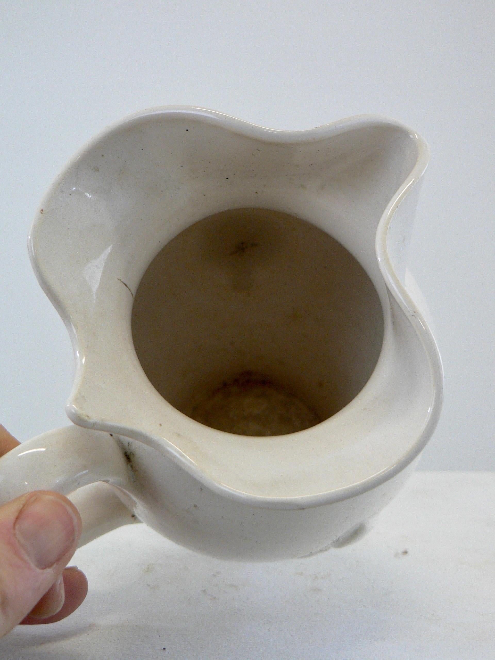 European A white glazed ceramic water pitcher with a fleur-de-lys decorations France  For Sale