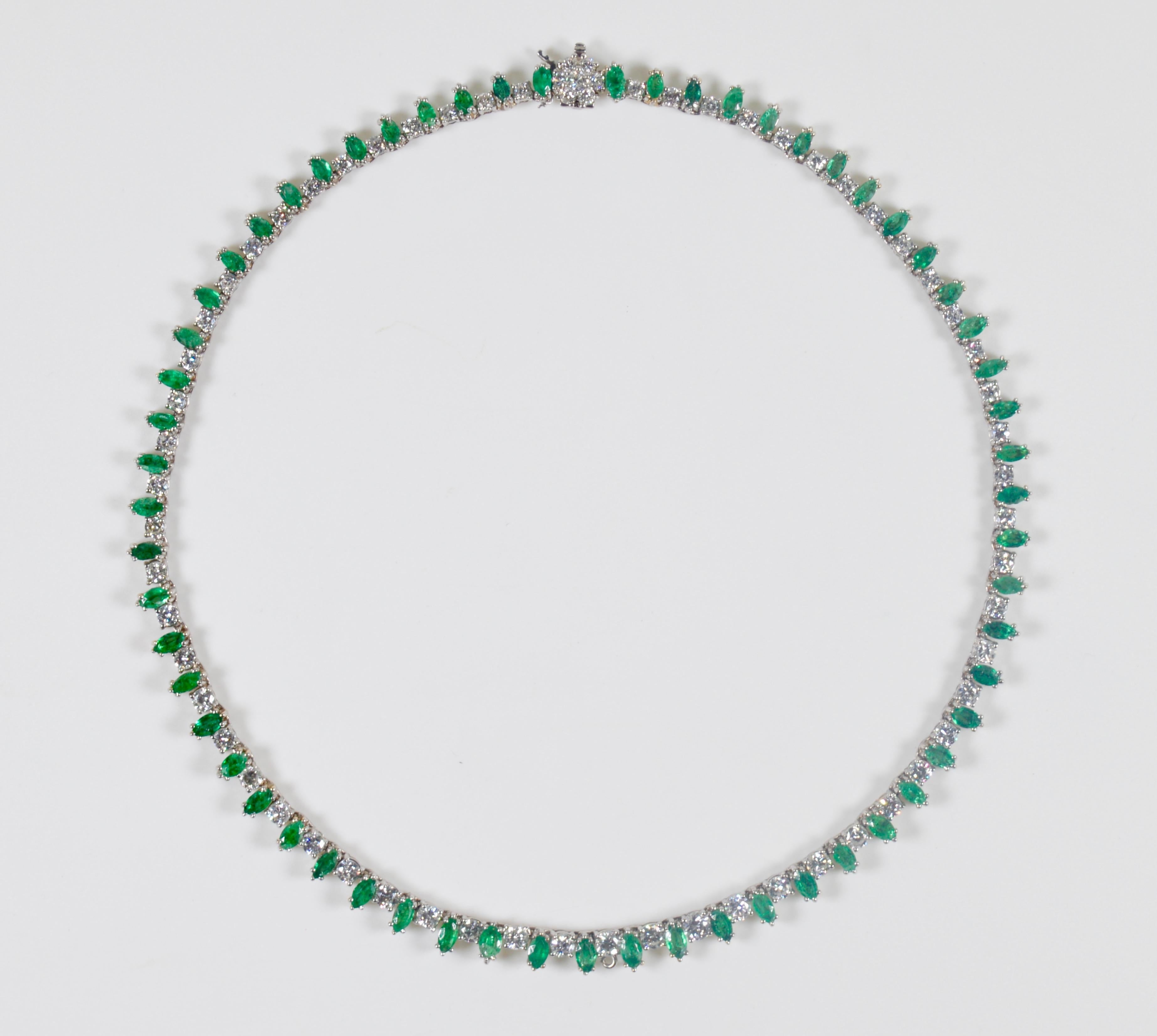 A beautiful white gold, diamond and emerald riviere necklace containing 67 round brilliant cut diamonds weighing approximately 5.35 carats total and 61 marquise shape mixed cut emeralds weighing approximately 3.60 carats total. Many of the emeralds.