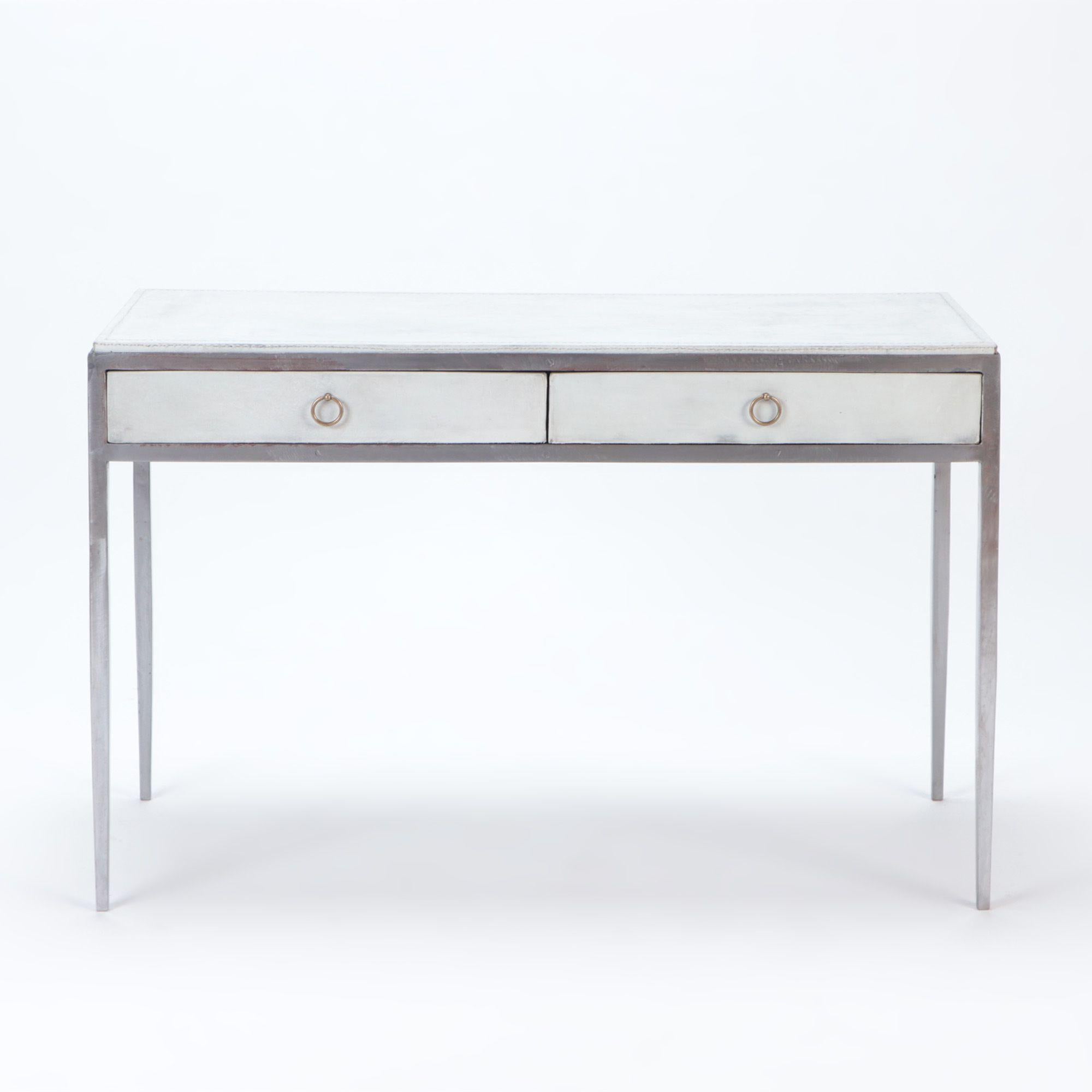 A white leather and polished iron writing desk, in the manner of Jean-Michel Frank. Two drawers with brass handles. Contemporary.