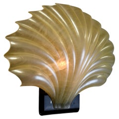 A white molded acrylic "Clam" shell mid century modern sculptural wall lamp.