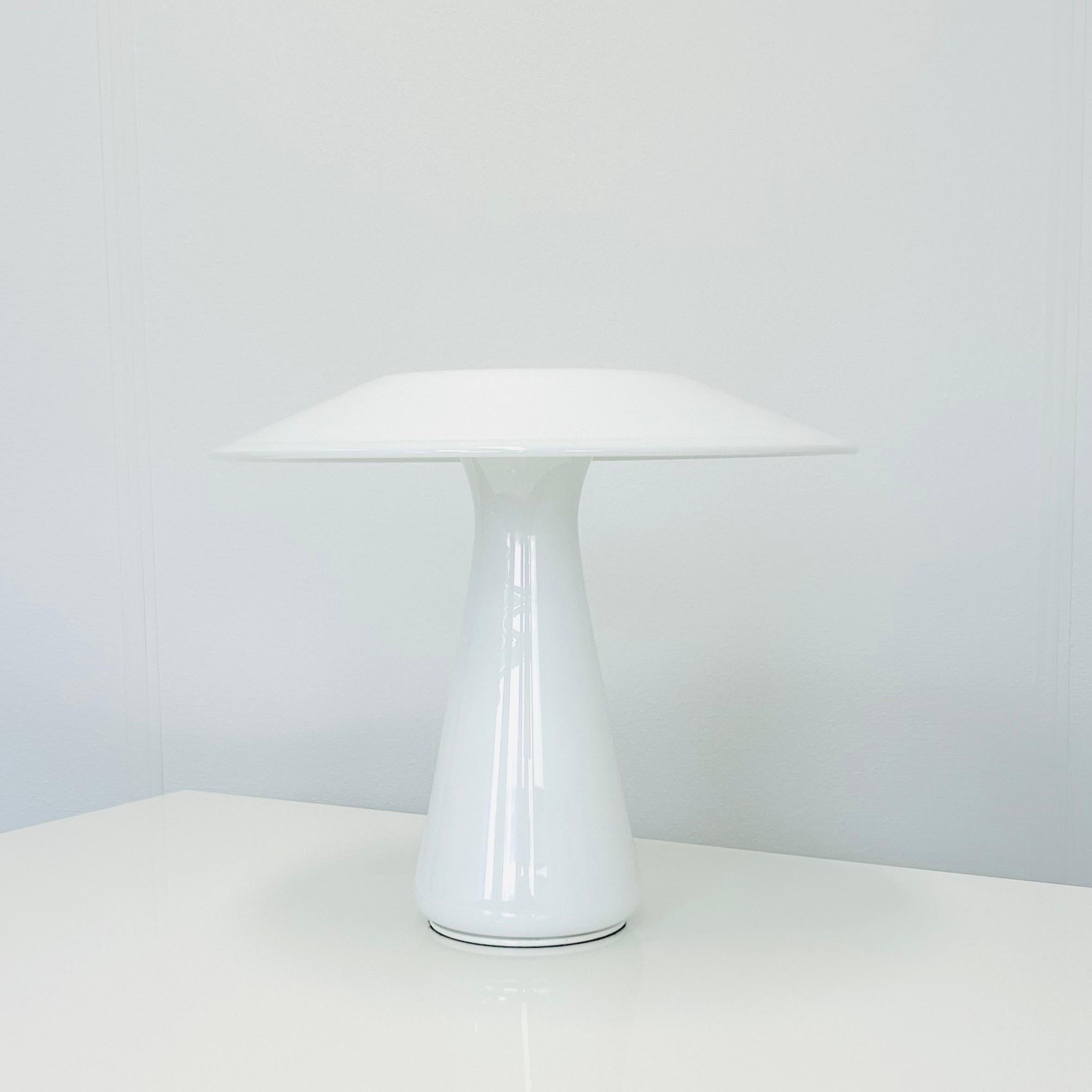 A mushroom shaped white glass desk lamp designed by female designer Sidse Werner for Danish Holmegaard Glasværk in 1985. It is called 'Phoenix' and is quit a rarity. It is in excellent vintage condition. The label is fully intact and the lamp has