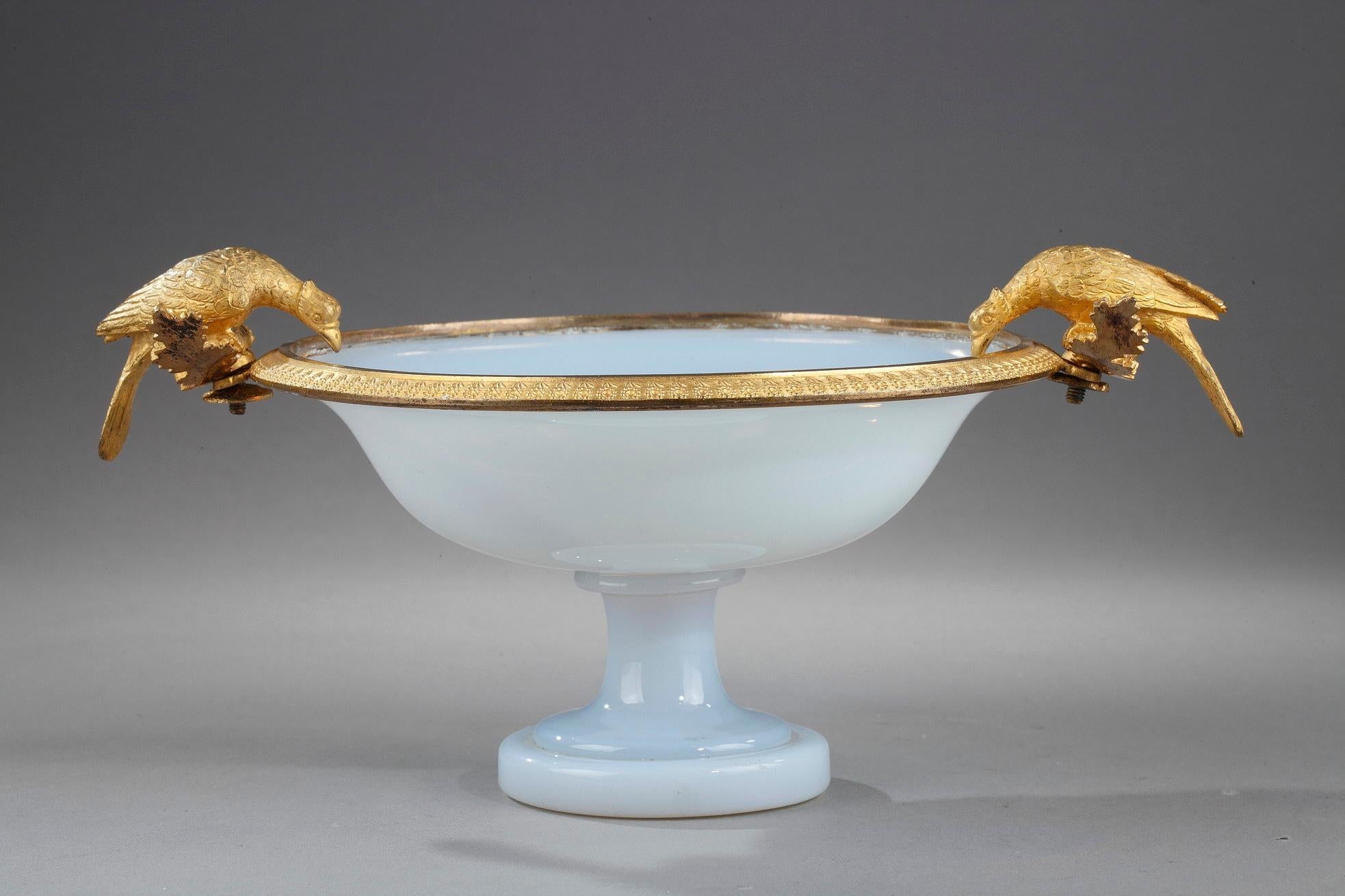 A white opaline cup on small pedestal and gilt bronze mount finely chiseled with flowers. Both handles shaped in pigeons resting on curved branches and bent to drink. The pure shape and silhouette, like the delicate colour give this cup a great
