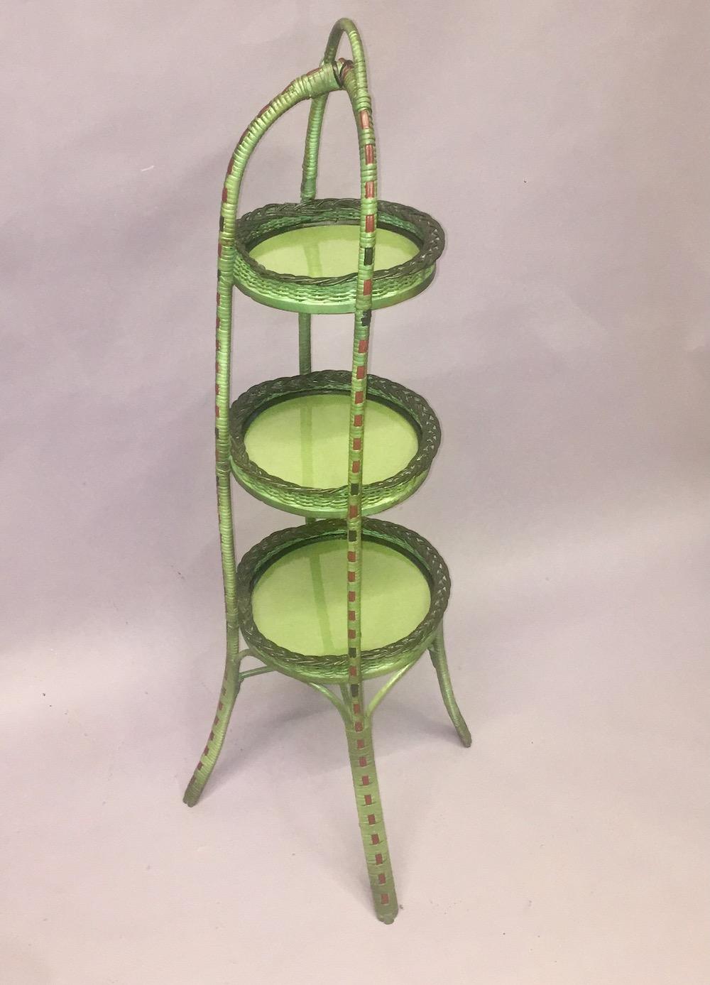 A lovely rare French green finished pie caddy / Hors-d'oeuvres server, American, attributed to Heywood Wakefield Company, Gardner Ma.C. 1910 This handled, three shelf server is done in a lovely unusual green shade with black and red decorated woven