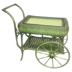A Wicker Rolled Sided Serving Cart with Removable Tray in French Green Finish
