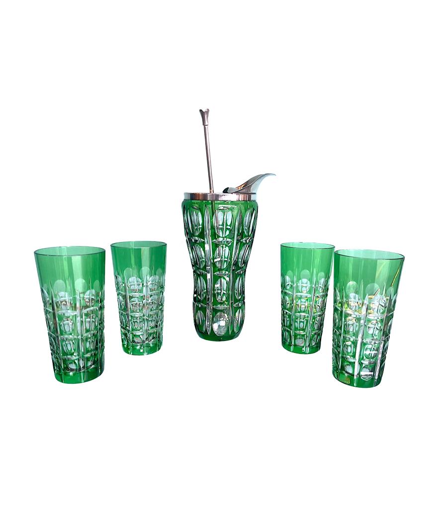A wonderful Wilhelm Wolff 1940s crystal and silver plated cocktail jug in stunning green colour with silver plated pouring spout and ice sieve top, with four matching cut glasses and Alpacca silver muddling spoon.