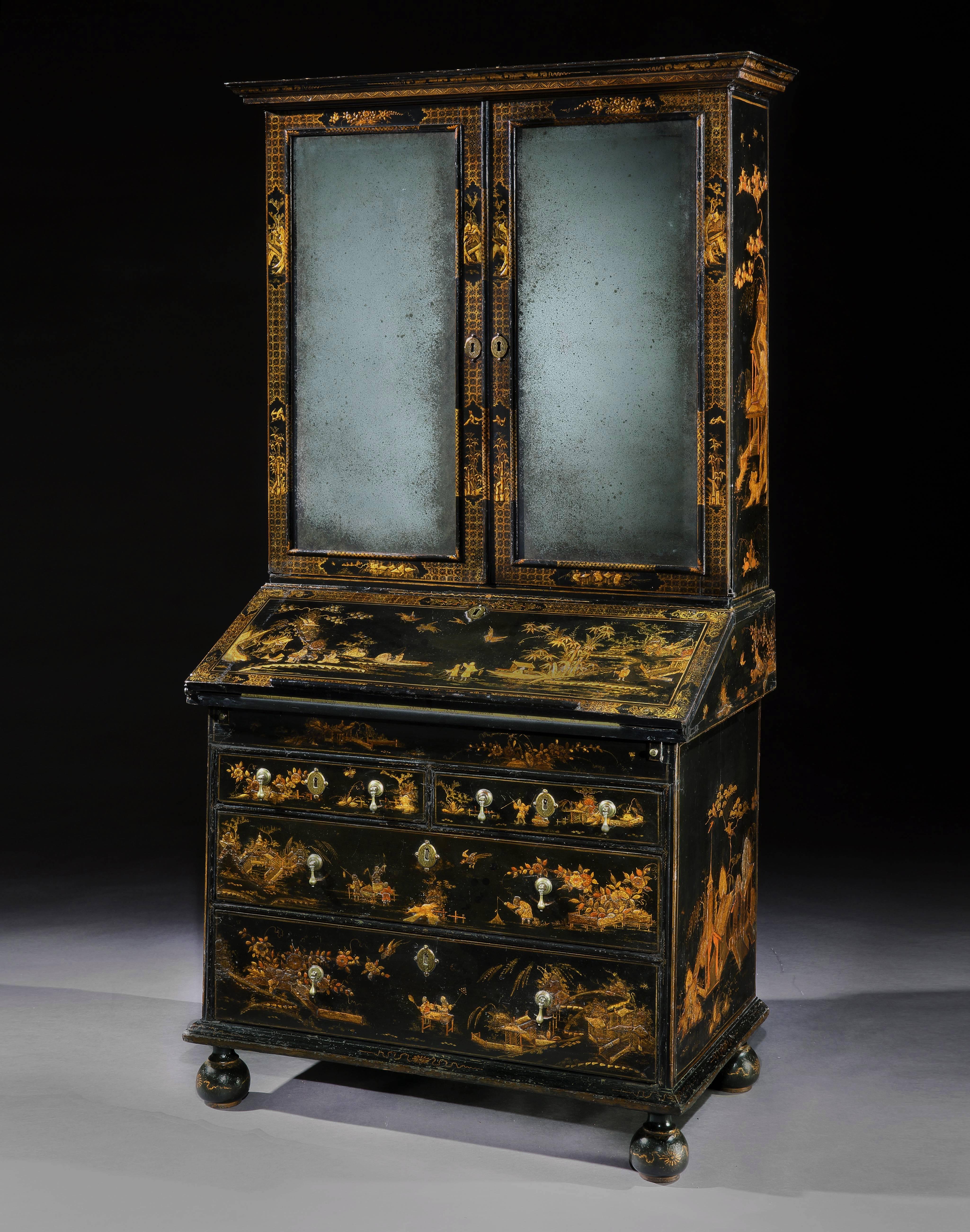 A rare William and Mary lacquered bureau cabinet, profusely decorated with gilded motifs depicting genre themes. The upper part enclosing adjustable shelves behind two bevelled mirrored doors above a fall front bureau, opening to reveal drawers,