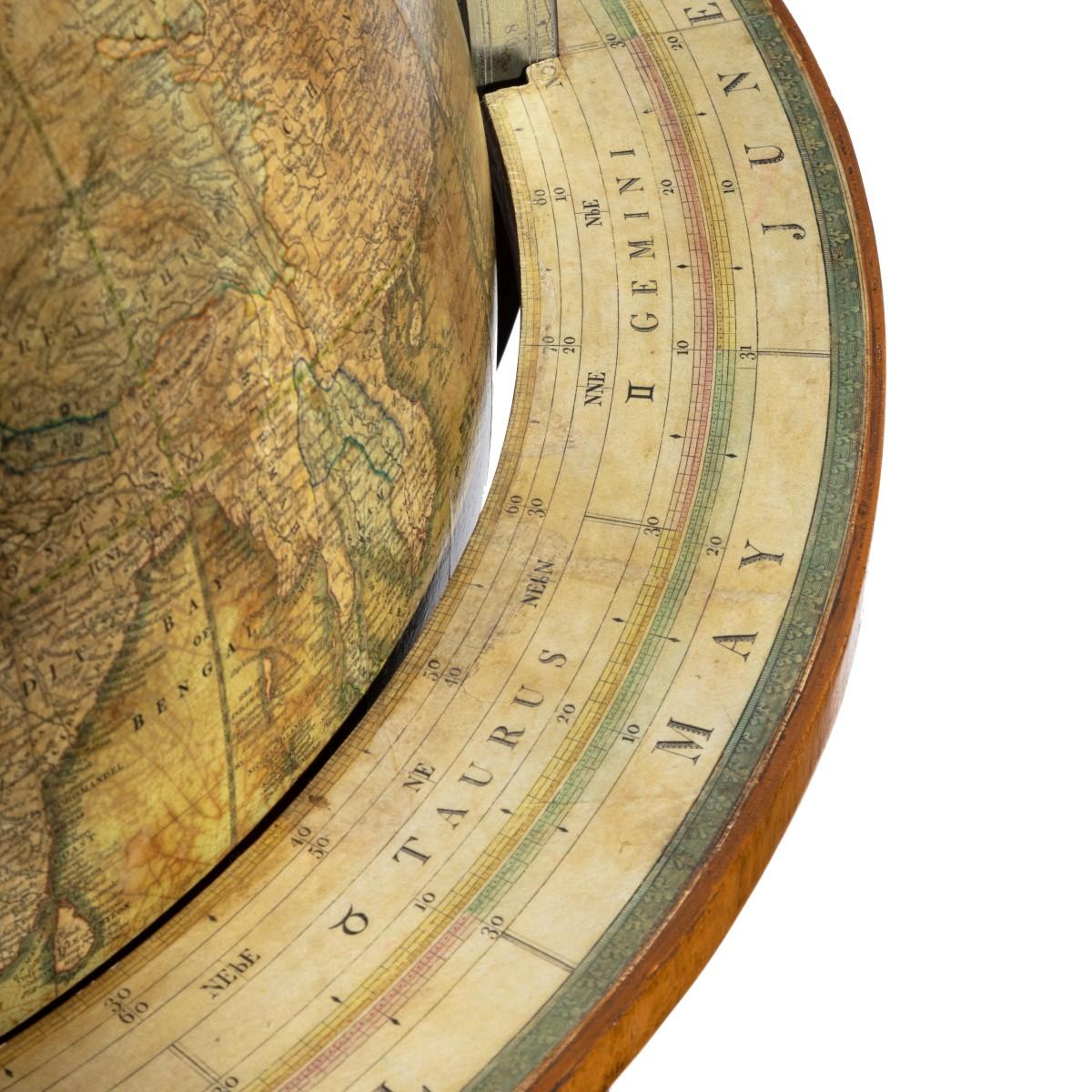 A William IV 20 inch terrestrial globe by Cruchley, set on a carved oak stand the four ribs and three scrolling legs united by an acanthus carved baluster, with the original compass rose and castors, the papers updated to 1853 and inscribed