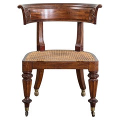 A William IV Carved Mahogany and Caned Library Chair