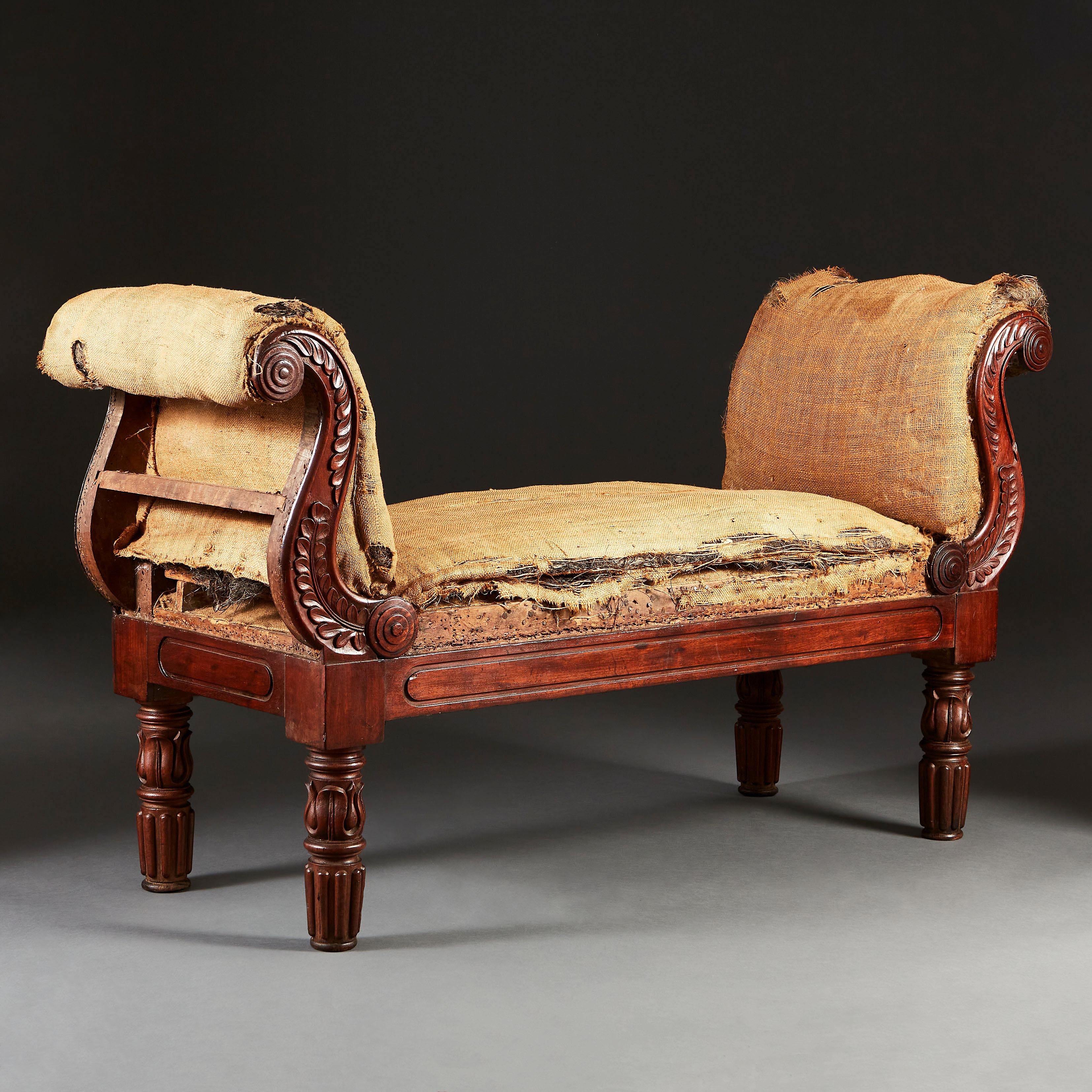 A fine mid 19th century mahogany window seat with scrolling arms carved throughout with fine foliate designs, turned legs with stylized acanthus. The horsehair upholstered seat, now requiring upholstery.