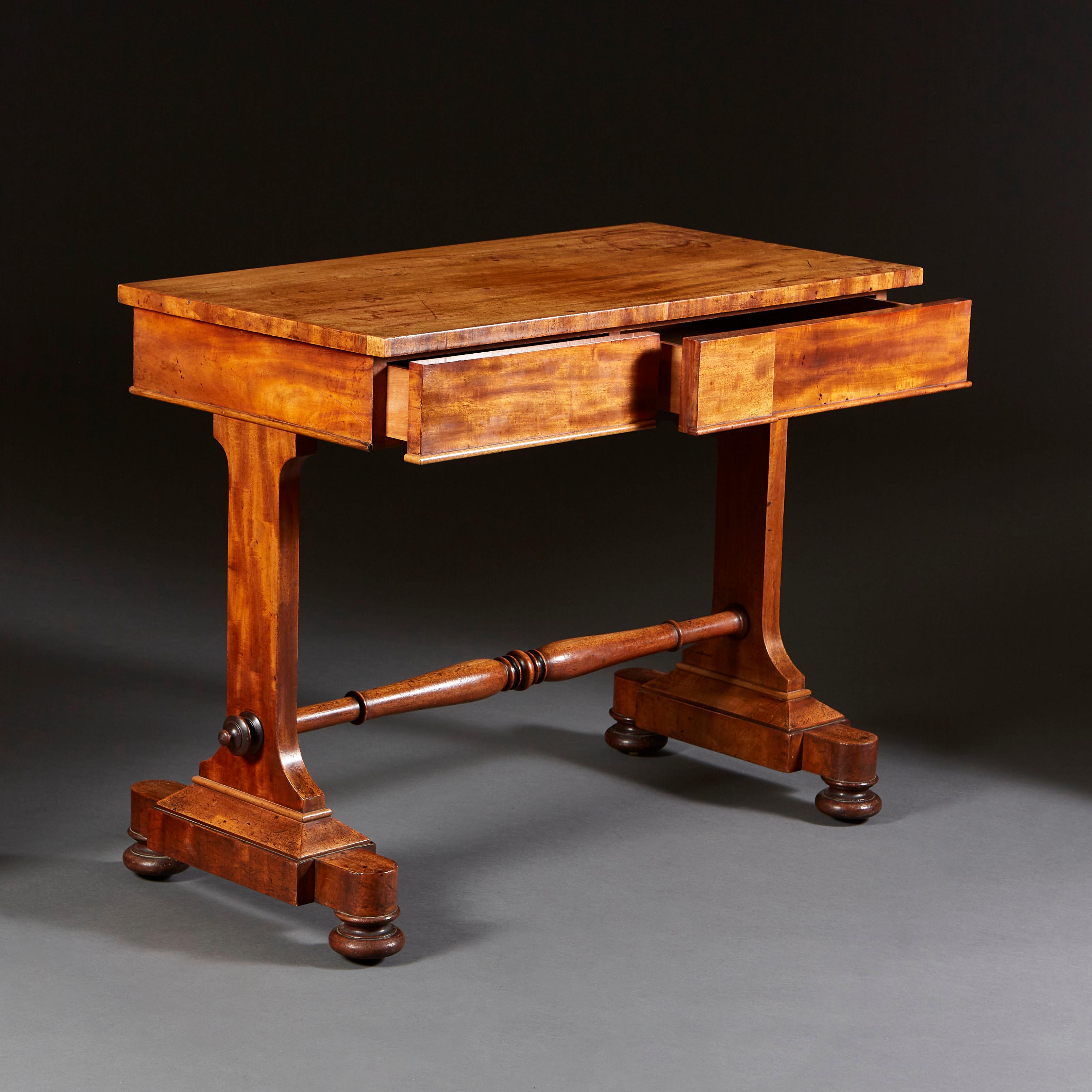 A William IV mahogany writing table, with fine patinated to the top and sides, the frieze with geometric moulding to the centre, with two drawers to the front, all supported on two uprights and turned stretcher, with bun feet.