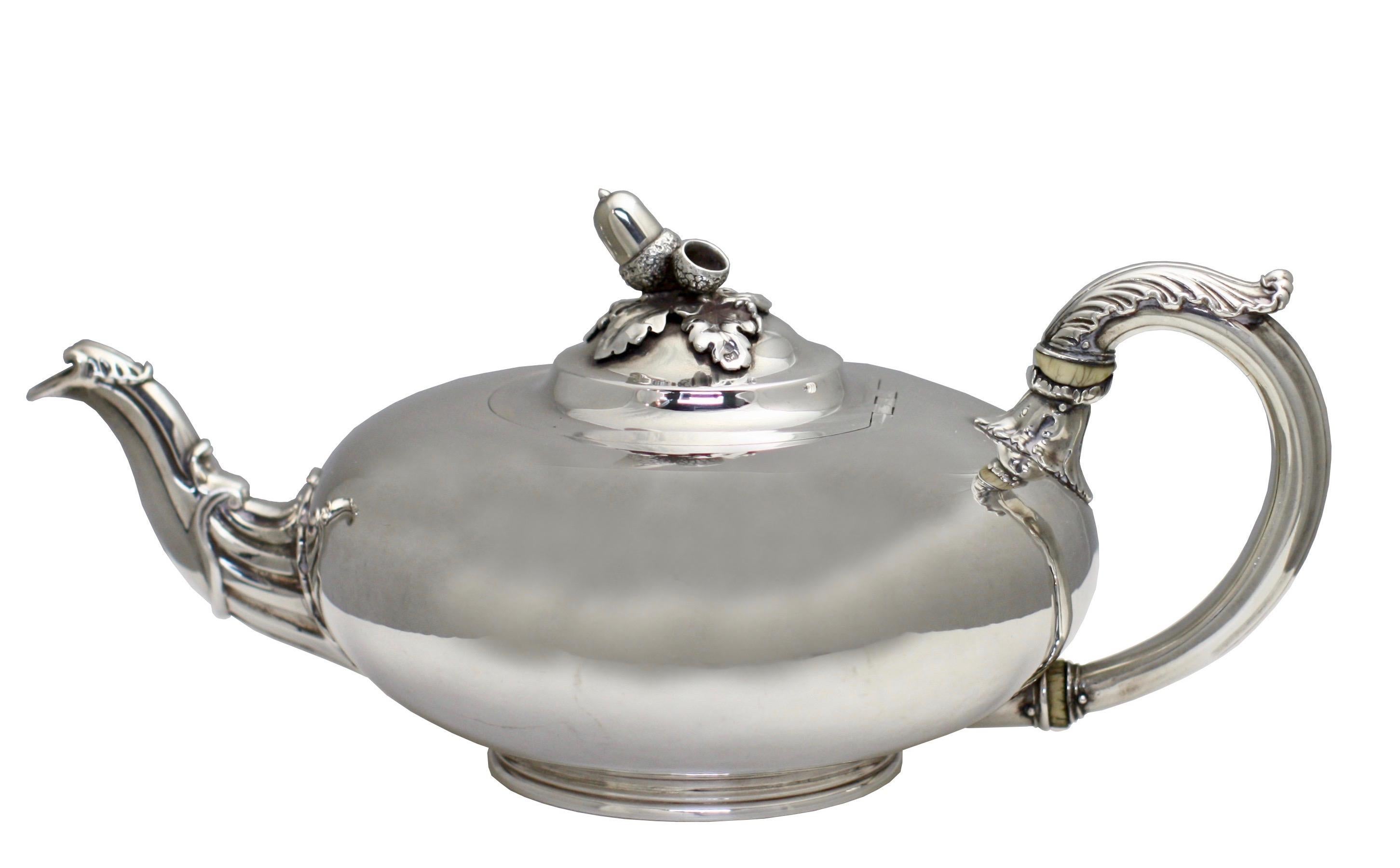 A William IV silver tea pot, Paul Storr for Storr & Mortimer,
London, 1832
plain compressed globular body engraved on one side with a crest, on a circular support, leaf-capped silver handle, applied foliate scroll lip, hinged cover with