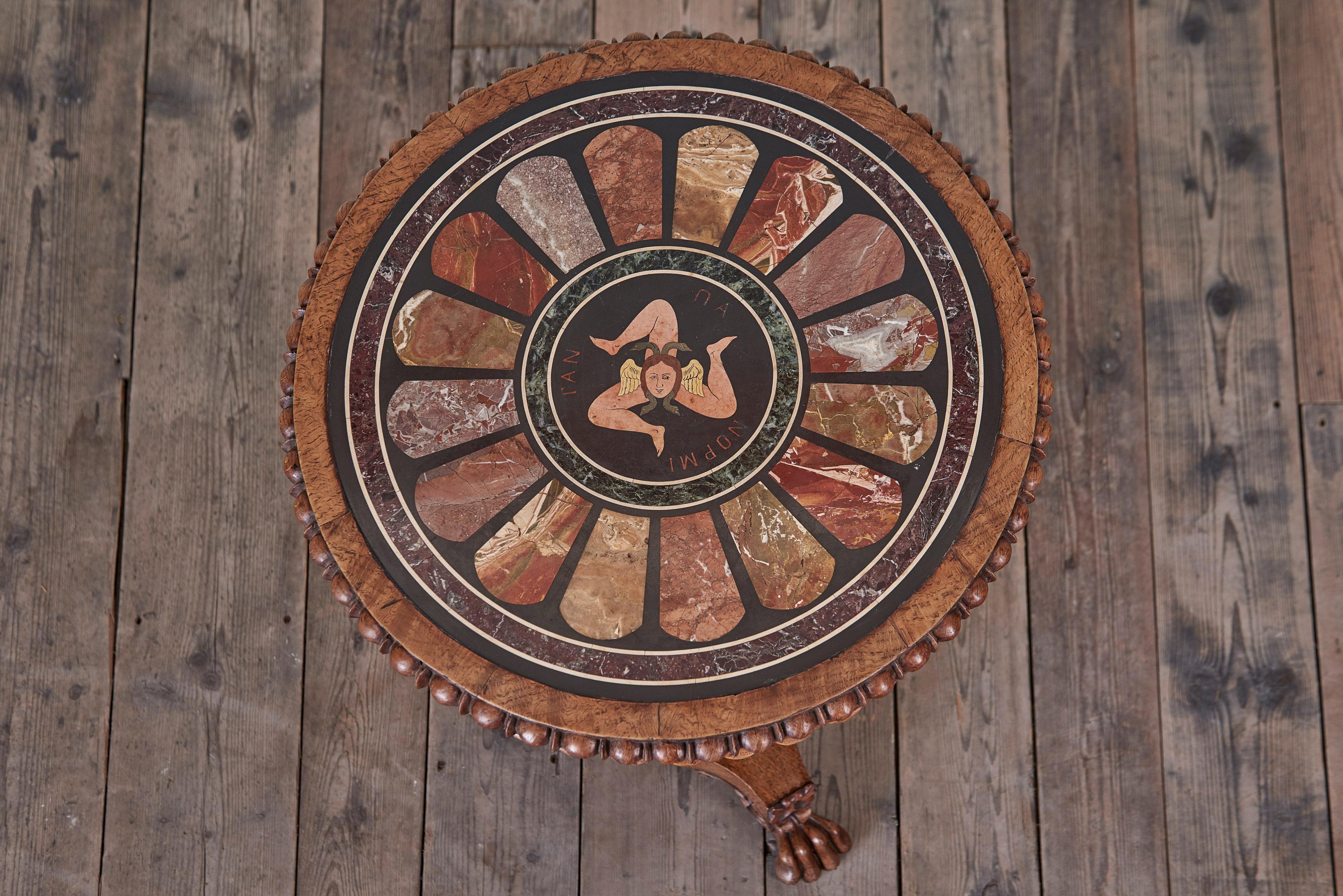 A William IV Specimen Marble Top Table

The circular top inlaid with a variety of intricate marble specimens, with a central inlaid ‘Trinacria’ tablet resting within a burr oak band, inside beaded edge, above a lotus leaf frieze  on a carved central