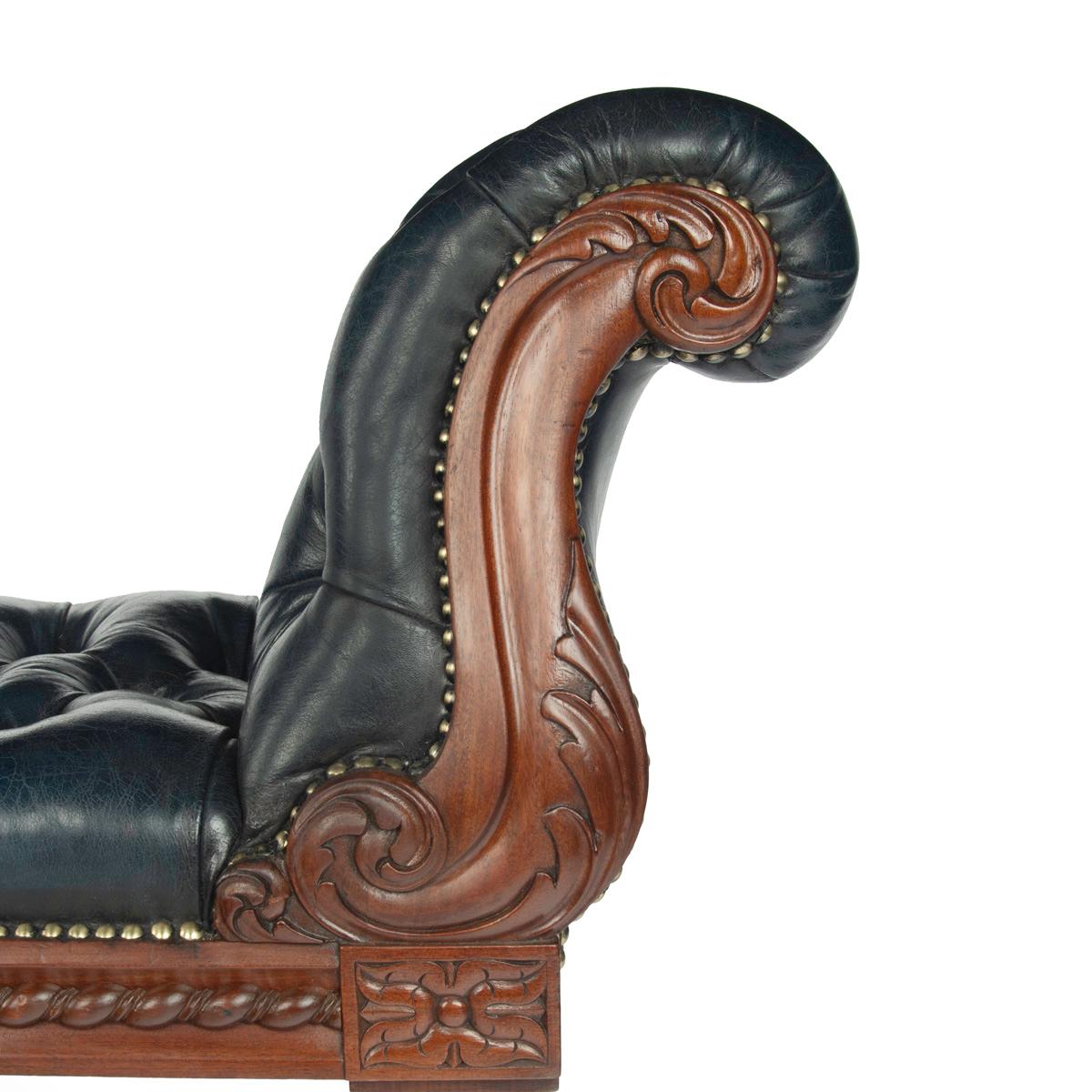 
A William mahogany bench seat, of long rectangular form, the long seat with an S­ scroll arm at either end, carved with feathery acanthus leaves on the arms and a guilloche border on the frieze, the turned tapering legs terminating in the original