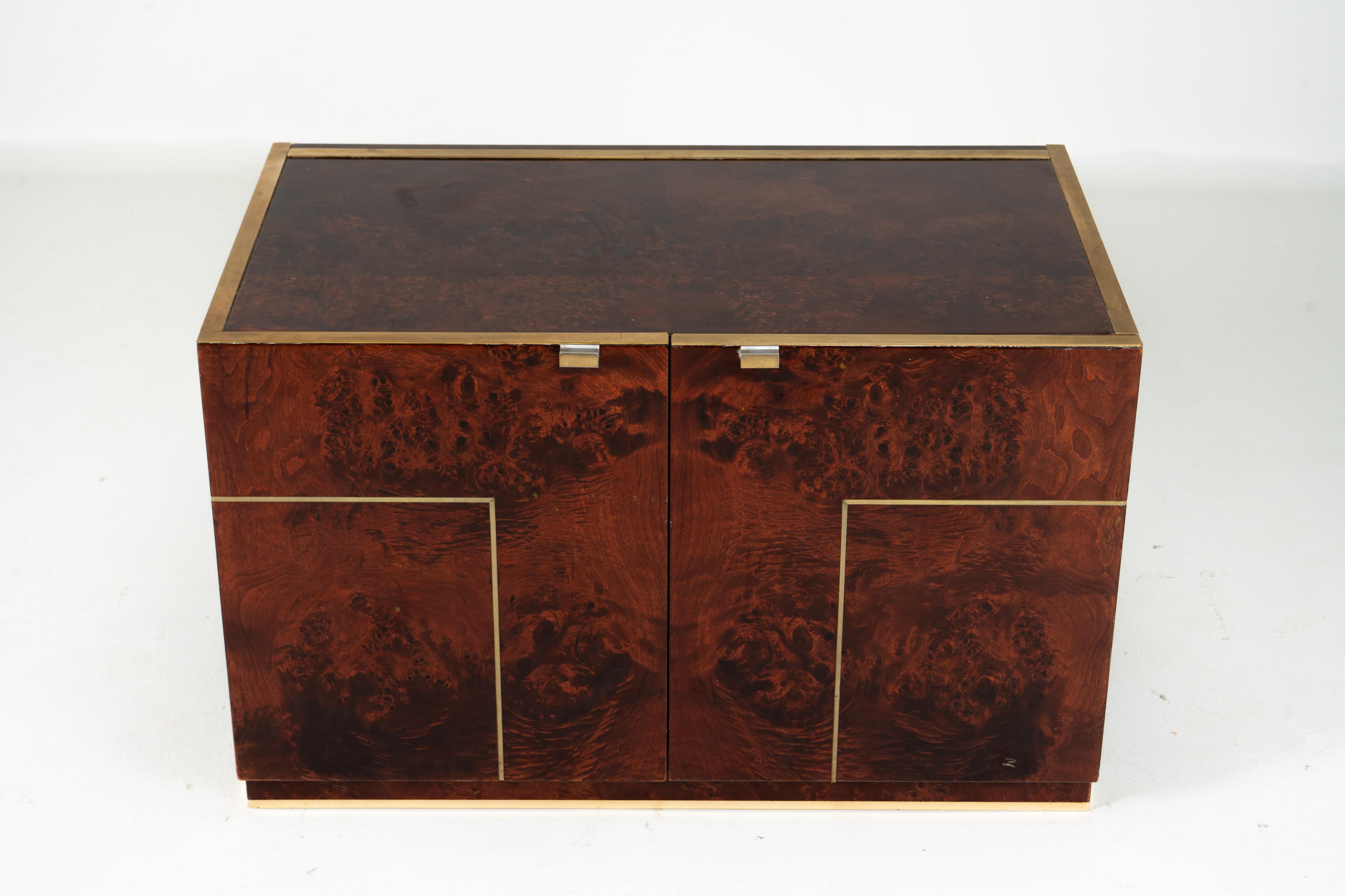 Sleek and timeless, this vintage storage chest by Willy Rizzo features lacquered amboyna veneers and refined brass inlay detailing. Designed in the early 1970s, it offers clean lines and a glamorous, polished aesthetic typical of Rizzo’s work. Rizzo