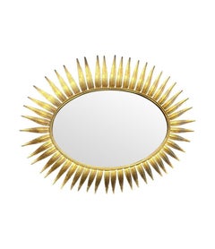 A wonderful 1950s gilt metal oval Spanish sunburst, eyelash mirror