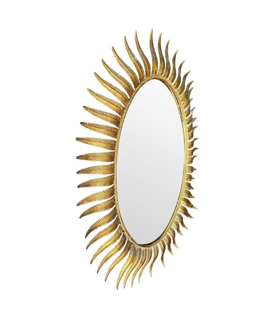 A wonderful 1950s gilt metal oval Spanish sunburst, eyelash mirror For Sale 1