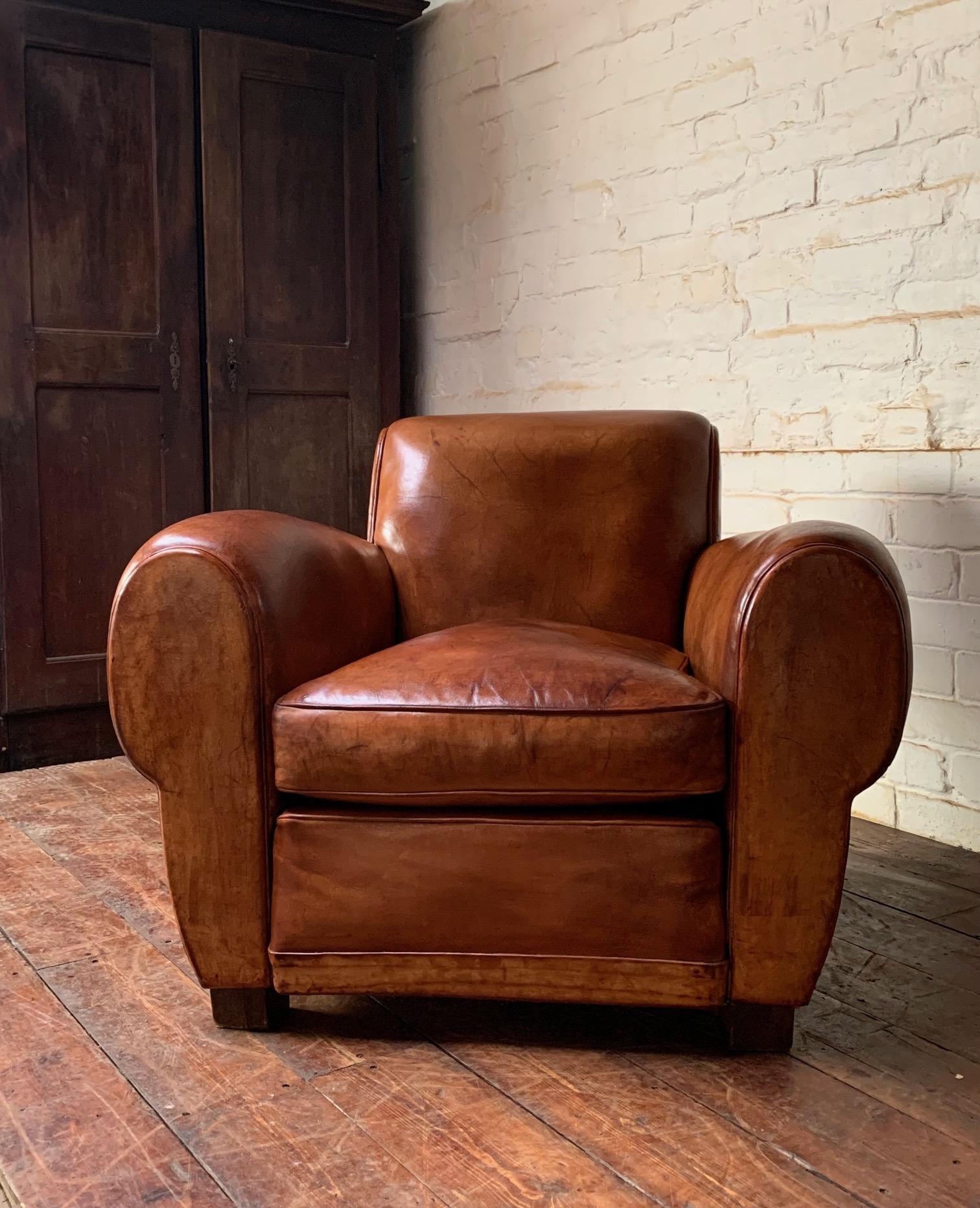 A Wonderful French Leather Club Chair, Caramel Gang-box Model, circa 1950’s

This is an impressive single chair with a lot of personality. Its condition, colour and patina are first class.
Its expressive oversized arms and scroll back give this
