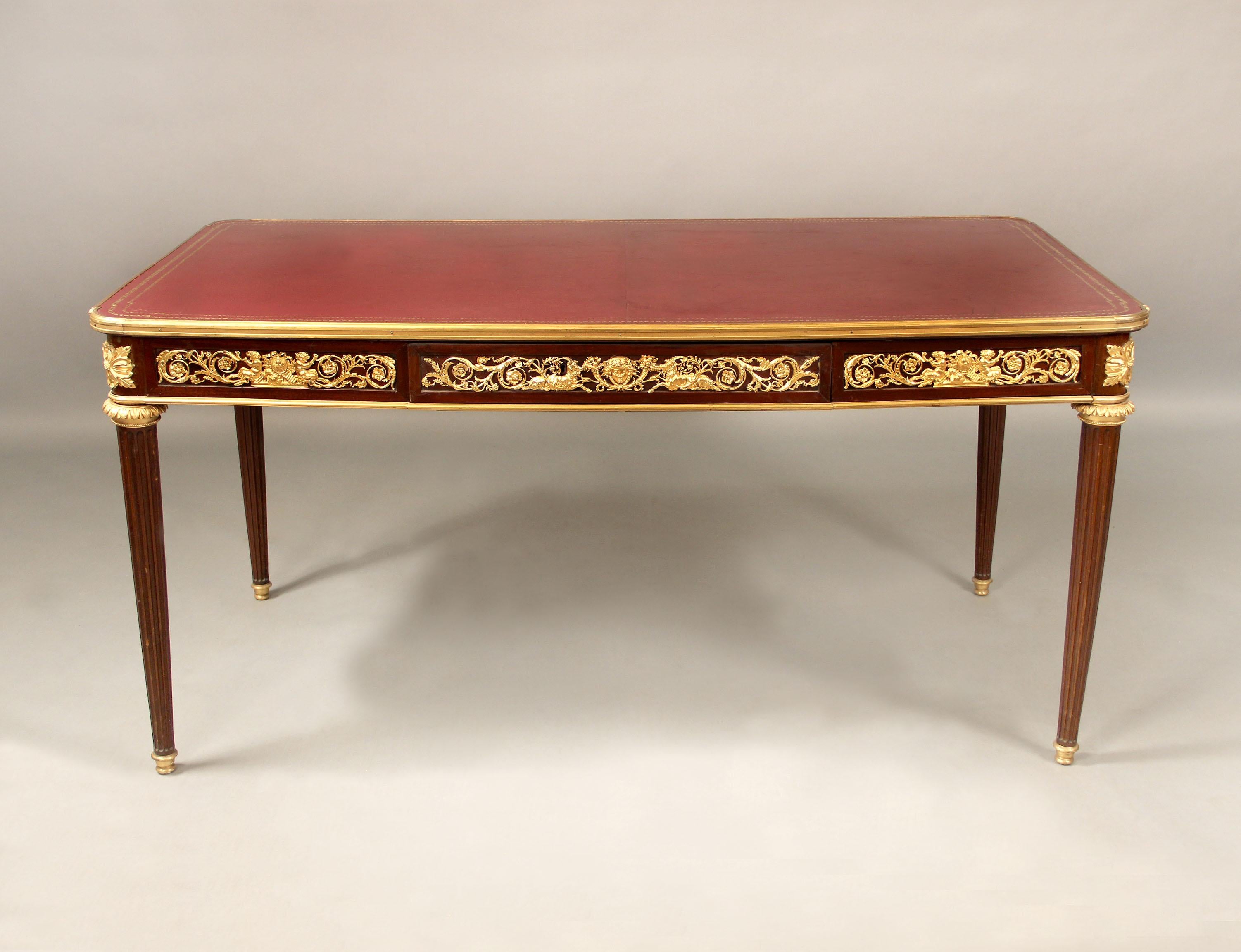 A Late 19th Century Gilt Bronze Mounted Louis XVI Style Desk

A leather top above a single bronze mounted drawer, centered bronze motif depicting a pair of rams centered by cornucopia and a maiden, surrounded by designs with satyrs and musical