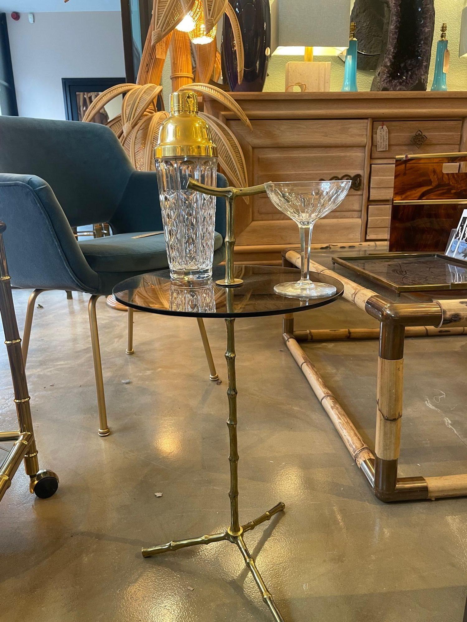 A wonderful pair of 1960s Maison Baques, sold brass, faux bamboo martini tables with smoked glass tops and faux bamboo top handle. Really lovely quality design with great natural bamboo detail and a great size. Price is for individual table as sold