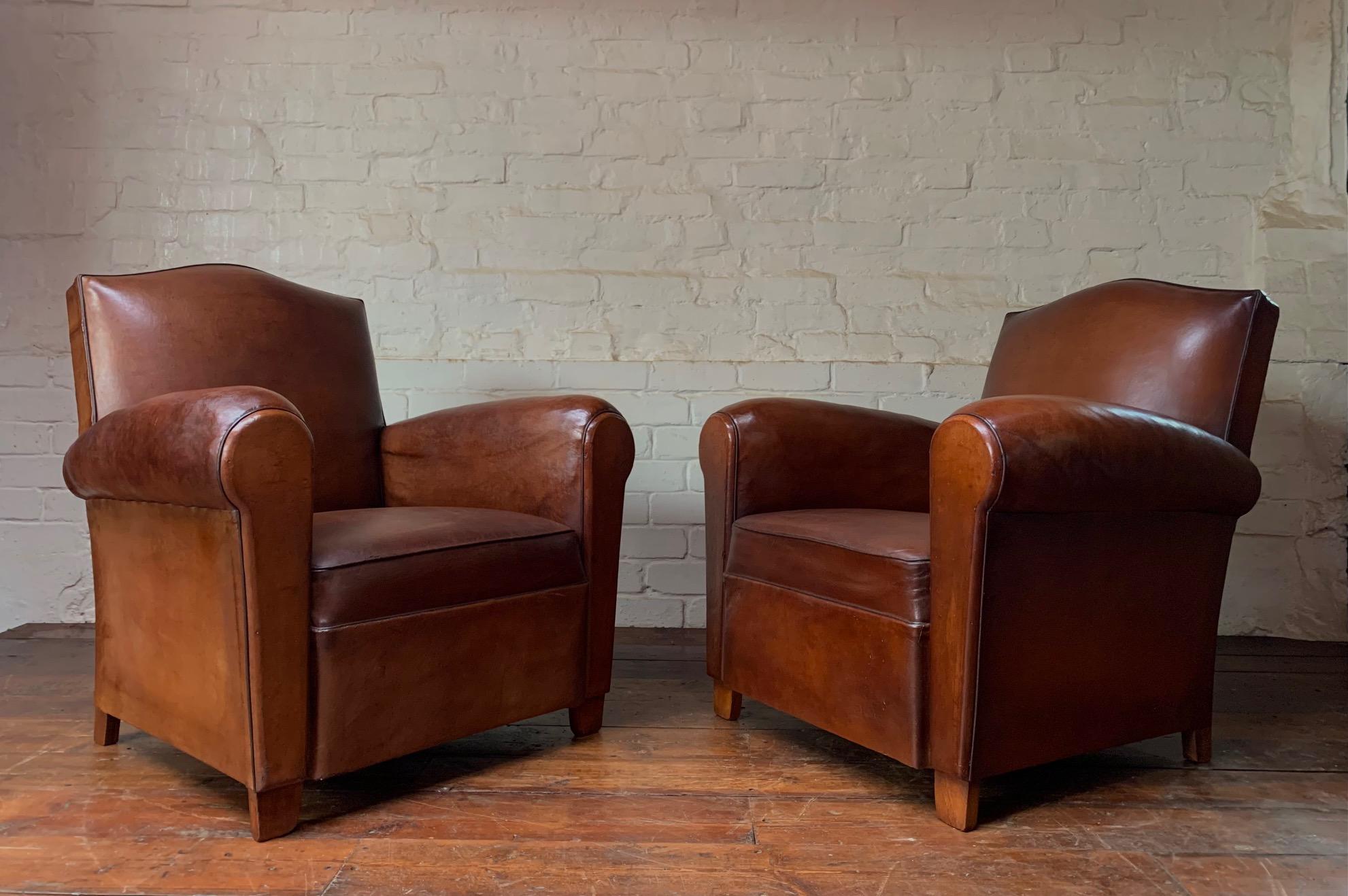 These are beautiful chairs. The original Havana brown leather has aged perfectly. After being cleaned and nourished the leather has revealed a gorgeous patina of lighter brown and chestnut. The condition of these chairs are almost perfect and the