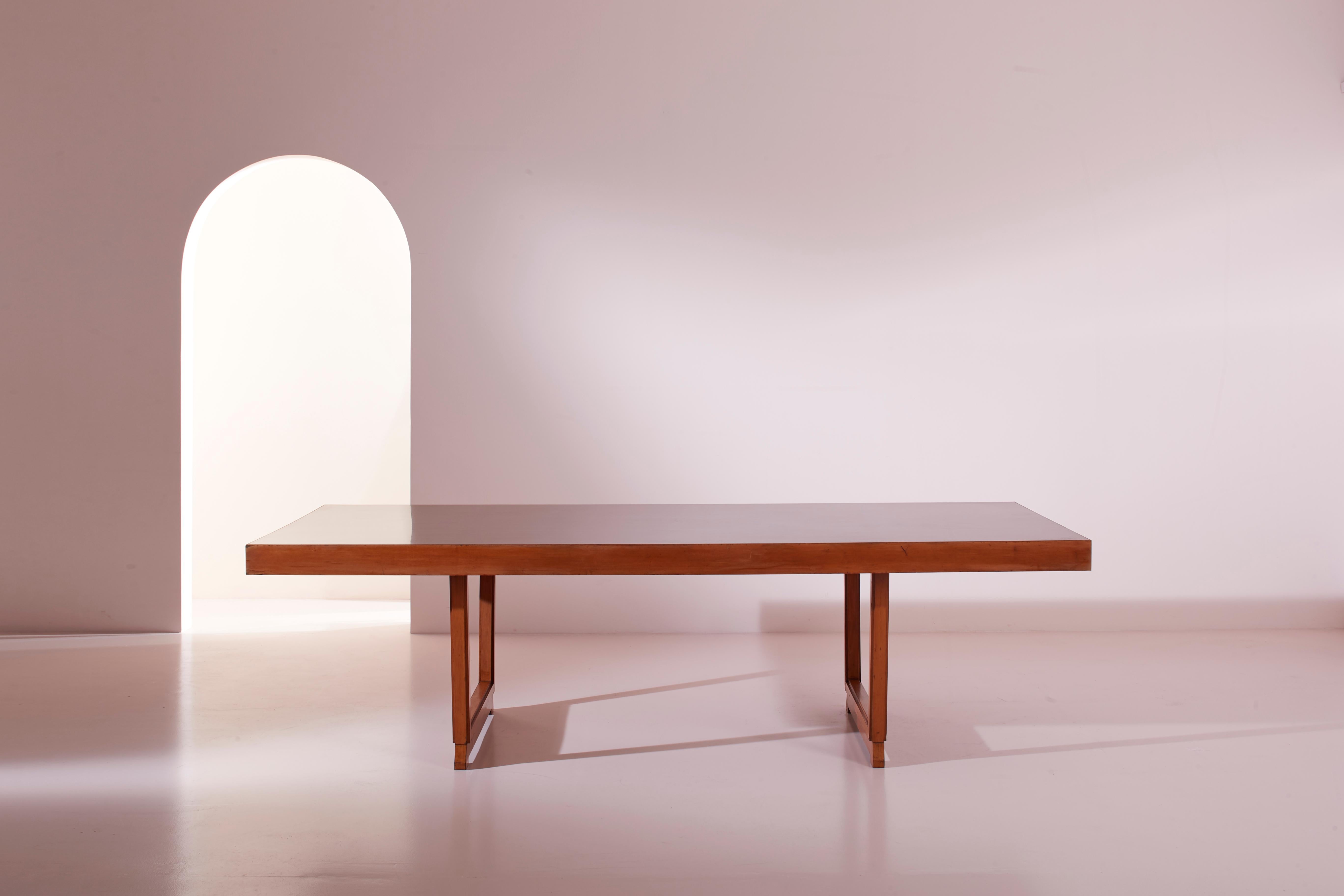 A large table, produced in Italy during the Sixties, crafted from wood and Formica, is perfect for furnishing a conference room, a spacious dining area, or any setting where socializing requires ample space to accommodate a large number of