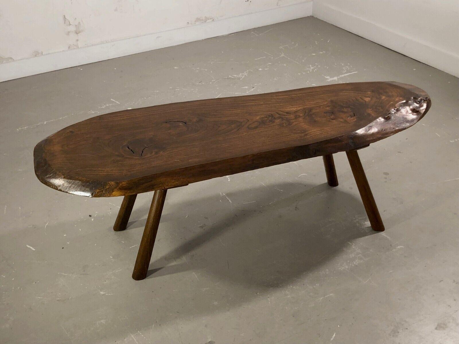 A wide free-form coffee table in the spirit of George Nakashima. Made in France by anonymous artist. A spectacular slice of tree forms the sensual top of this table, including its surrounding bark and internal veinures, fixed on 4 dynamic conical