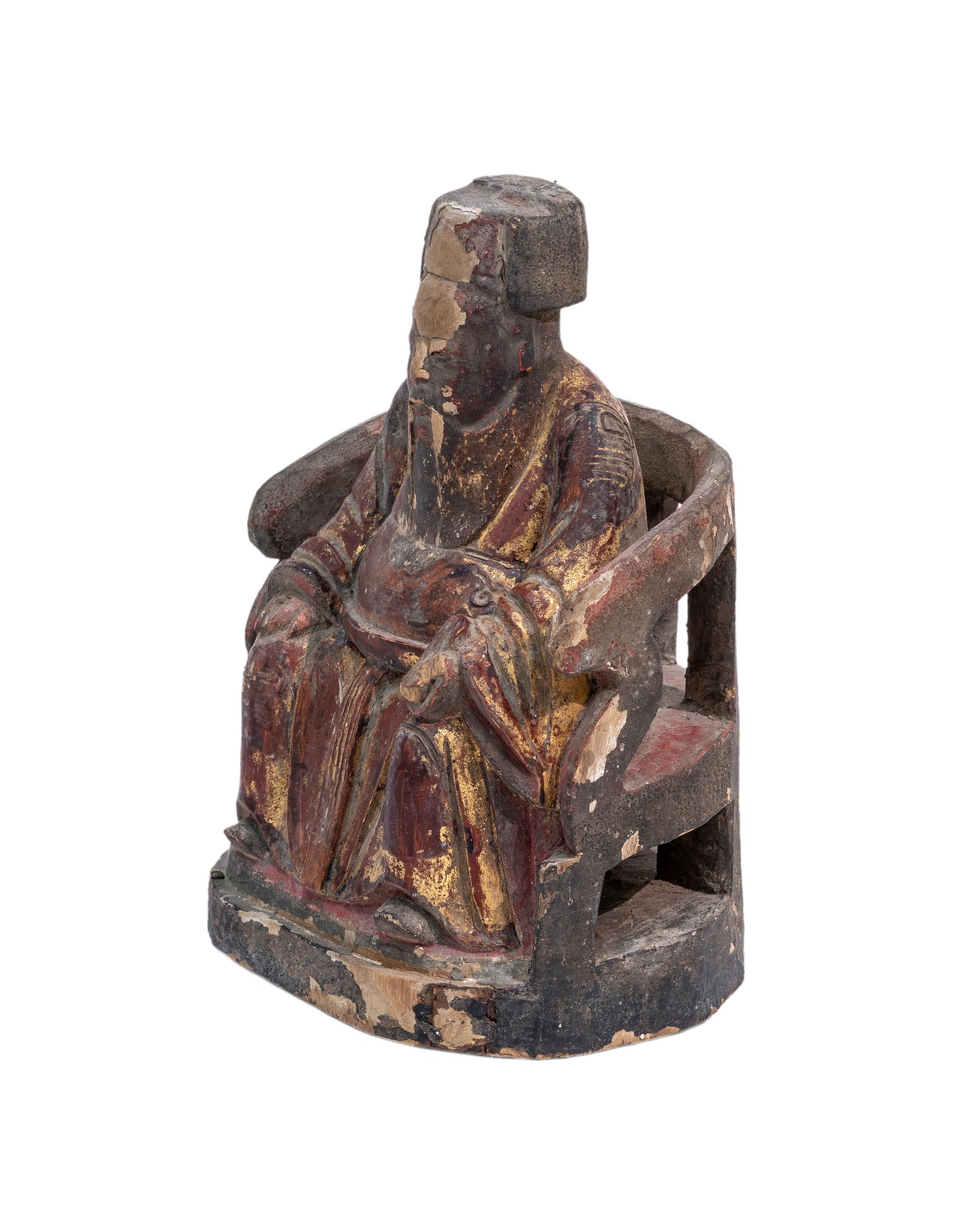 A wooden sculpture of a Chinese Earth God, from Fujian province, China. The deity and his armchair is carved out from a single piece of wood. This Earth God has a kindly face, the sculpture is in very good shape and it is in 100% original condition.