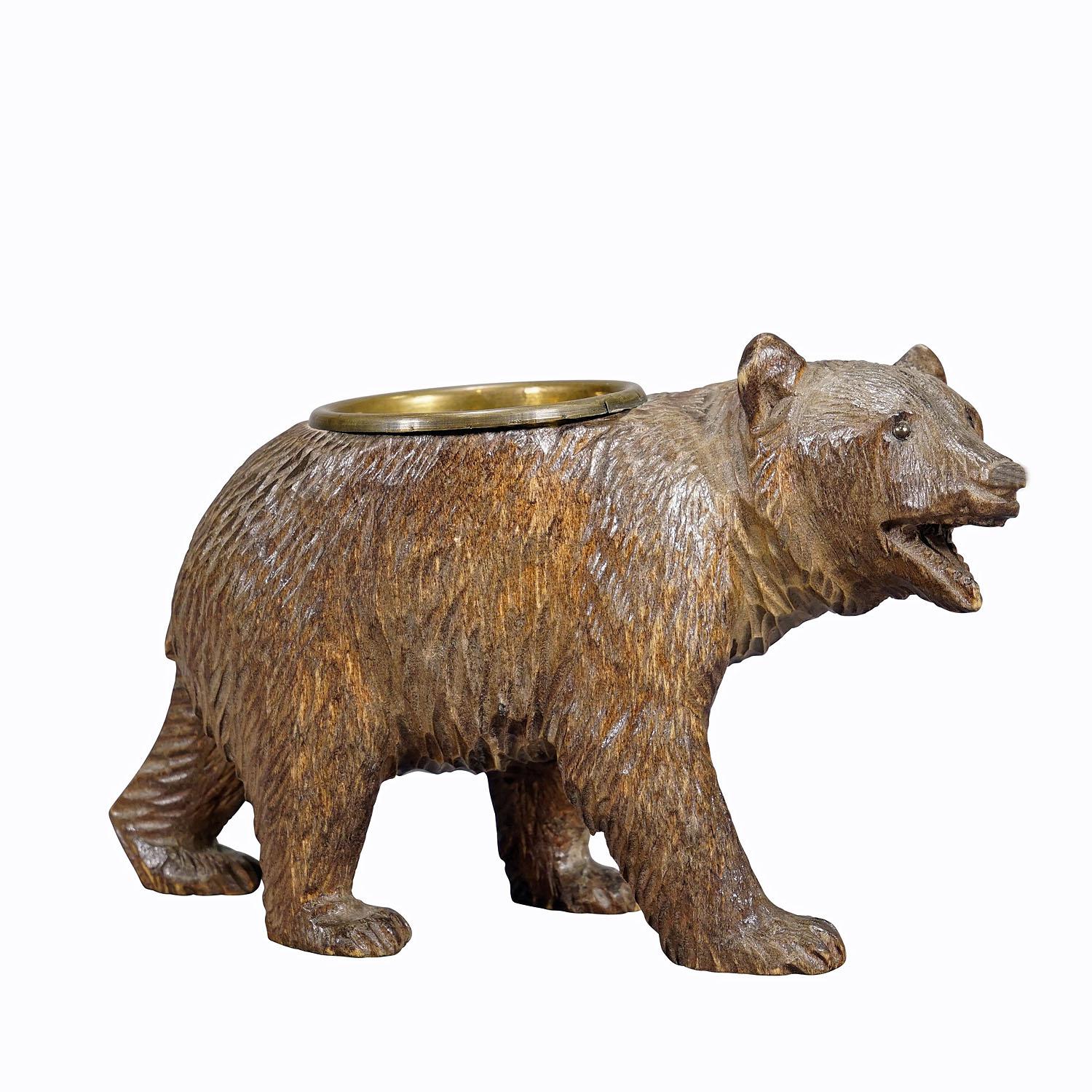 A Wooden Carved Black Forest Bear with Brass Bowl ca. 1920s
Item e7284
A nicely carved Black Forest bear with brass bowl for small utensils on his back. Executed in Brienz, Switzerland around 1920. Very good condition.

The tradition of wood