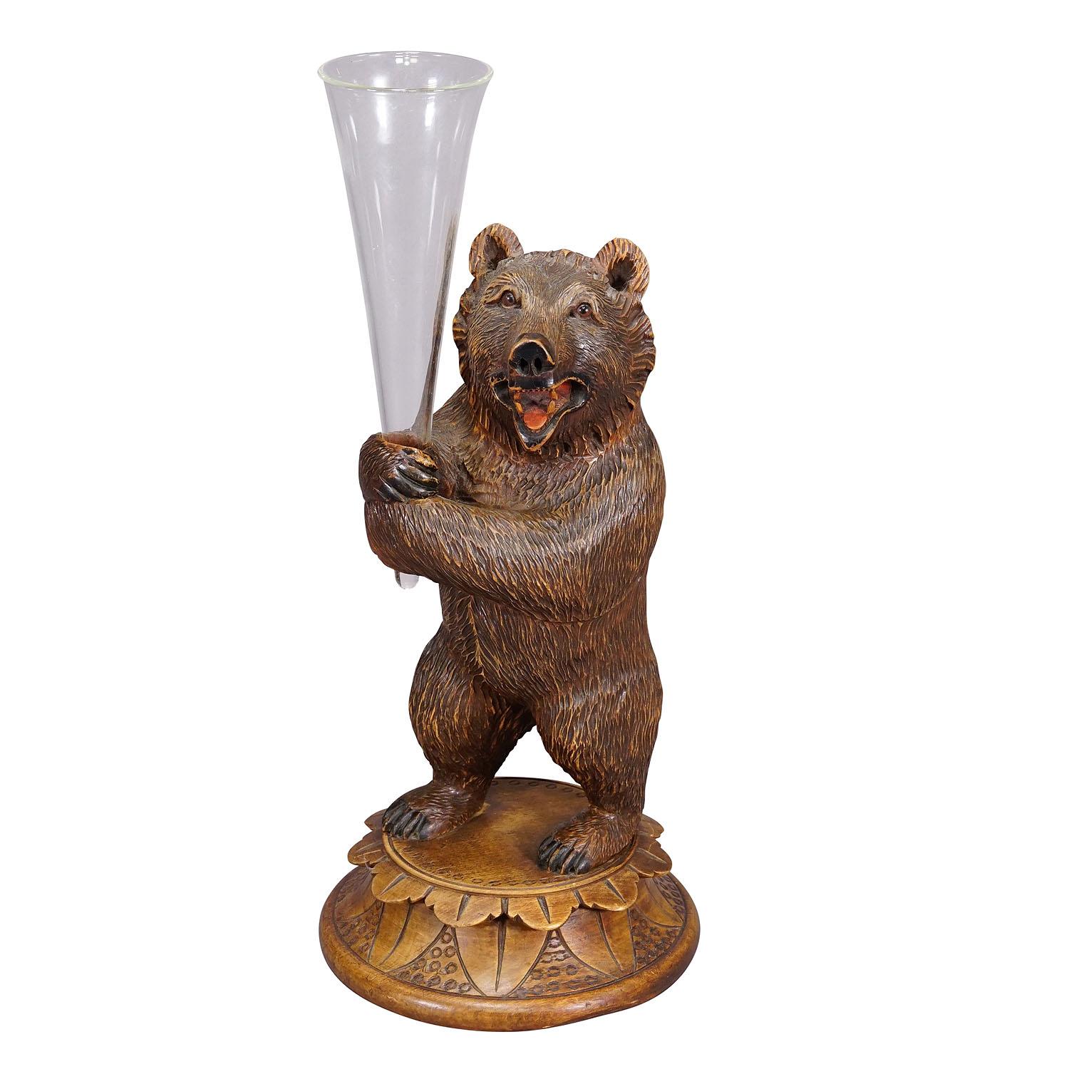 A Wooden Carved Black Forest Bear with Glass Vase ca. 1920
Item e7274
A nicely carved Black Forest bear holding a glass vase in its hands. Executed in Brienz, Switzerland around 1920. Very good condition. Heigt of the bear: 11.8' inches (30 cm). A