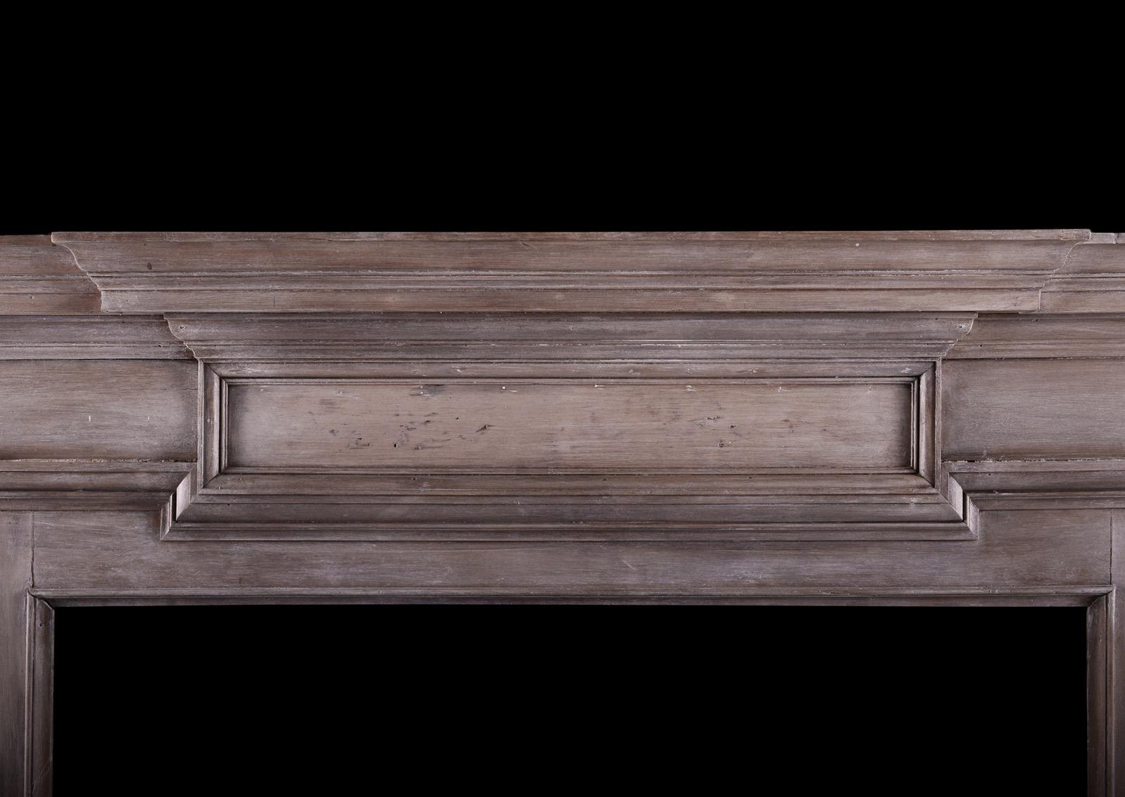 A wood fireplace in the Georgian manner. The moulded jambs surmounted by barrel frieze and centre plaque. Breakfront shelf above. English, circa 1900. Nice patina and finish to timber. 

Measures: Shelf width: 1628 mm 64 