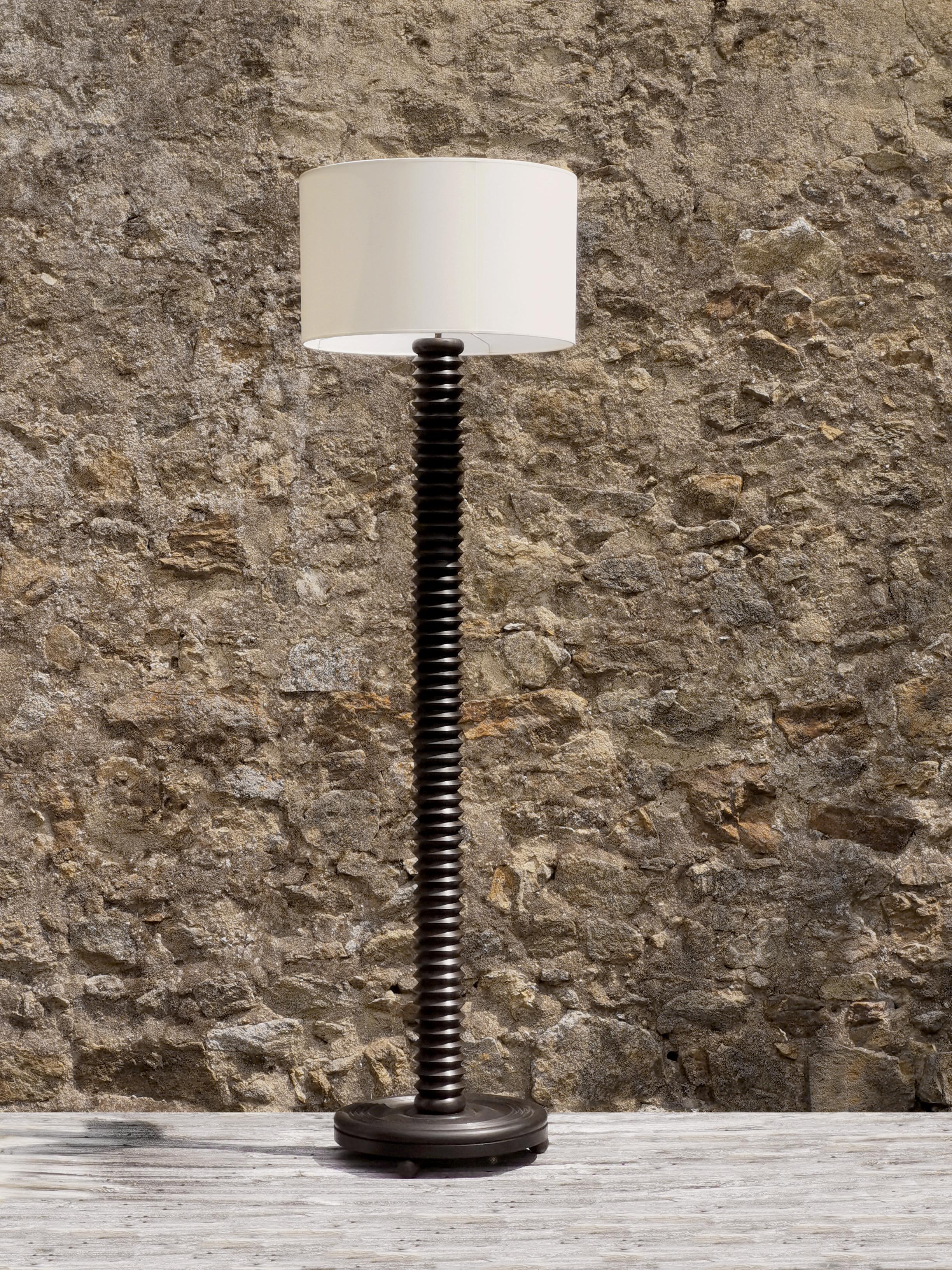 A powerful, elegant and rigorous floor lamp, Art-Deco, Modernist, Cubist, Constructivist, Machine-Age, massive darkened wood circular base mounted on 3 wooden spheres in a Machine-Age manner, thick and very graphic vertical axis remembering an