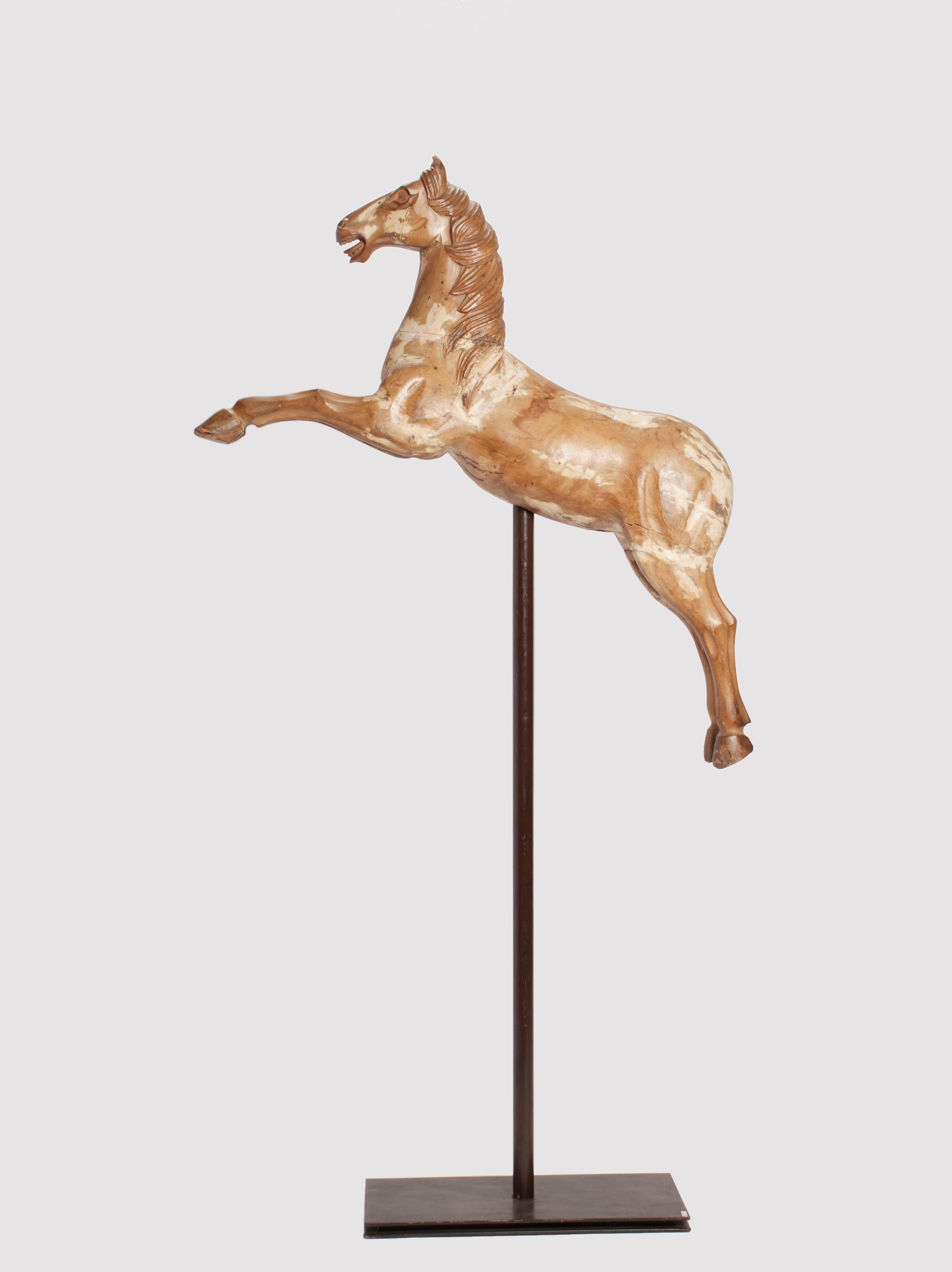 Italian wooden sculpture depicting a carousel horse launched in the act of ramping. Pale fruitwood. Modern metal base. The measurement refers to the horse only. Italy mid-18th century.