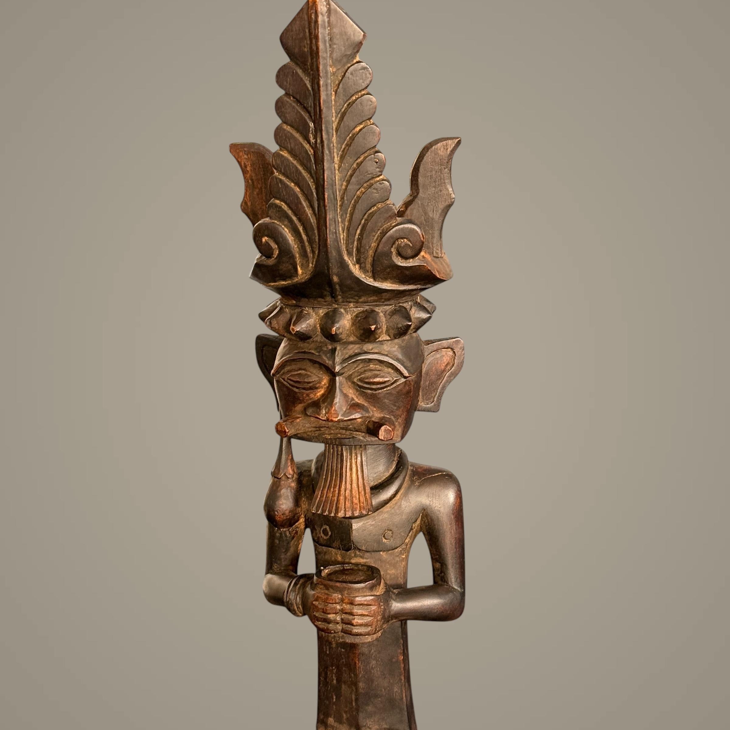 This wooden statue from Siraha Salawa, a noble Nias ancestor figure from Indonesia, is a striking example of Nias artistry and cultural heritage. Carved from a single piece of wood, this statue stands tall and proud, embodying the strength and