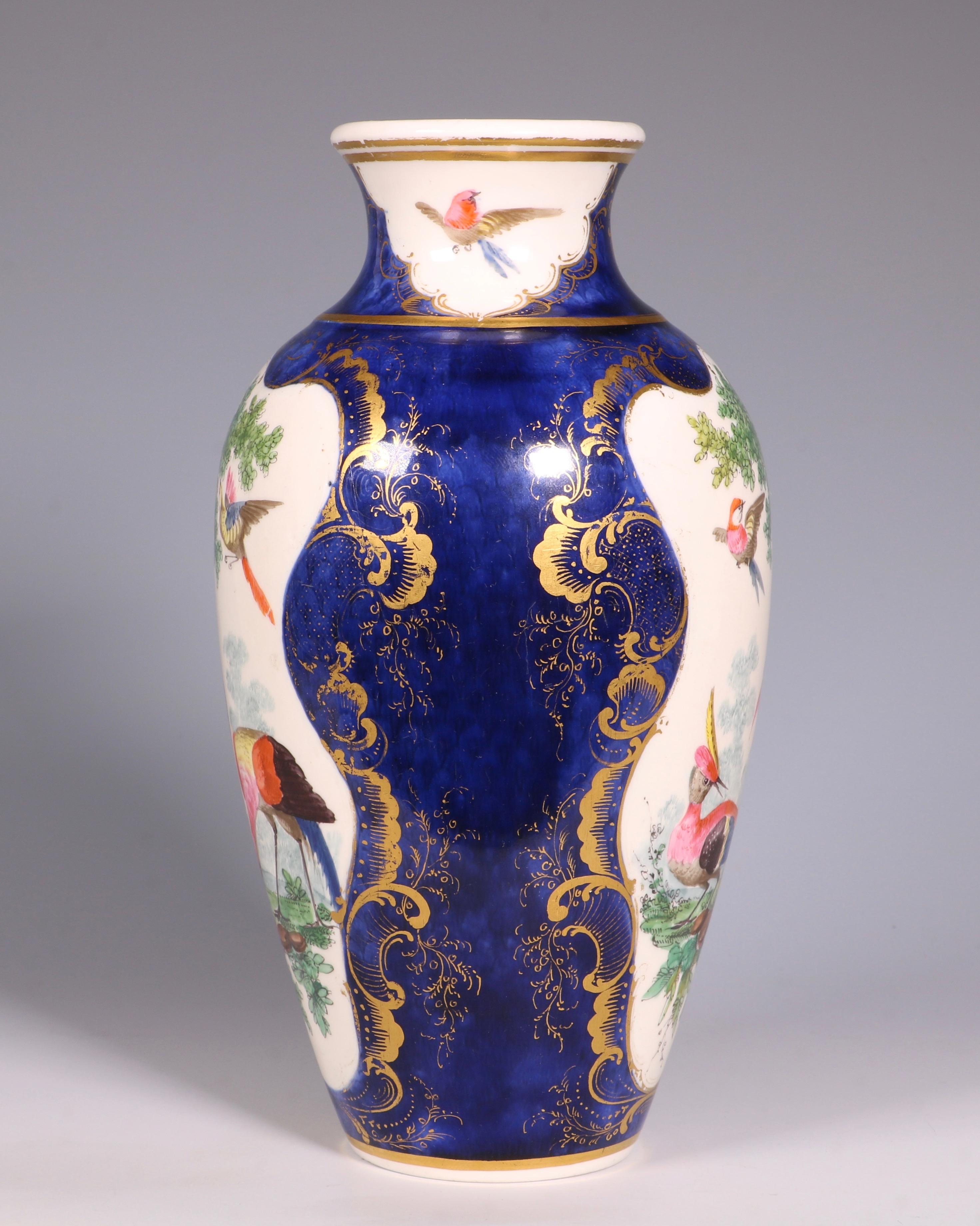 A Worcester soft paste blue ground vase, decorated with panels of exotic birds in landscapes. Within gilt rococo scroll borders.
Base with square seal mark, Worcester, circa 1772.




 