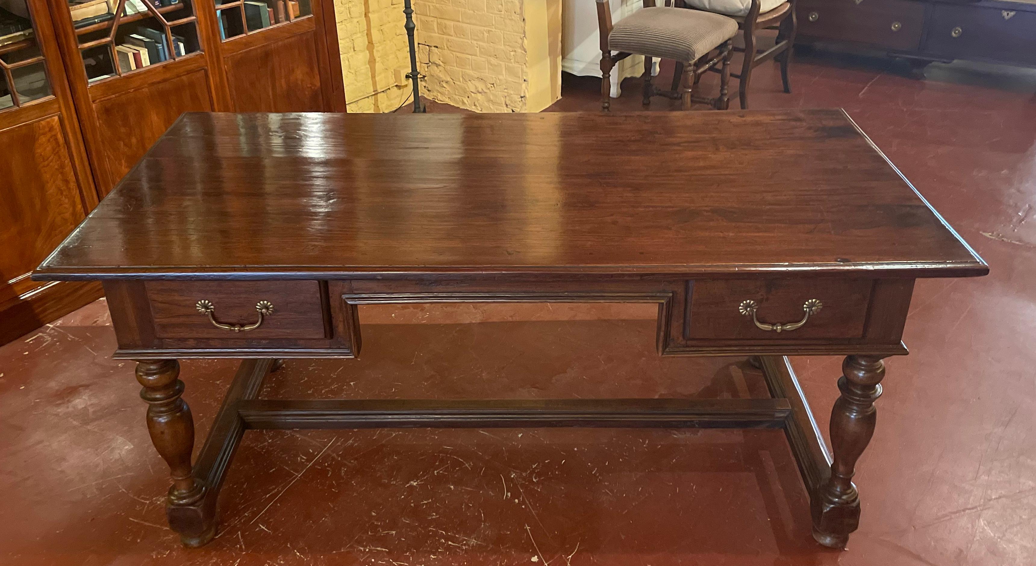 Very elegant writing desk from the Netherlands from the beginning of the 19th century in colonial wood
flat desk with two drawers which has a very elegant base with turned legs connected by an H spacer

Very beautiful table top with a beautiful
