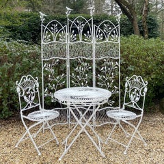 A Wrought-iron Dining Set with Screen and Bird and Branch Motif
