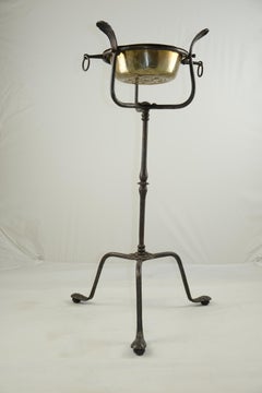 A wrought Iron Stand with a brass bowl , 17th Century