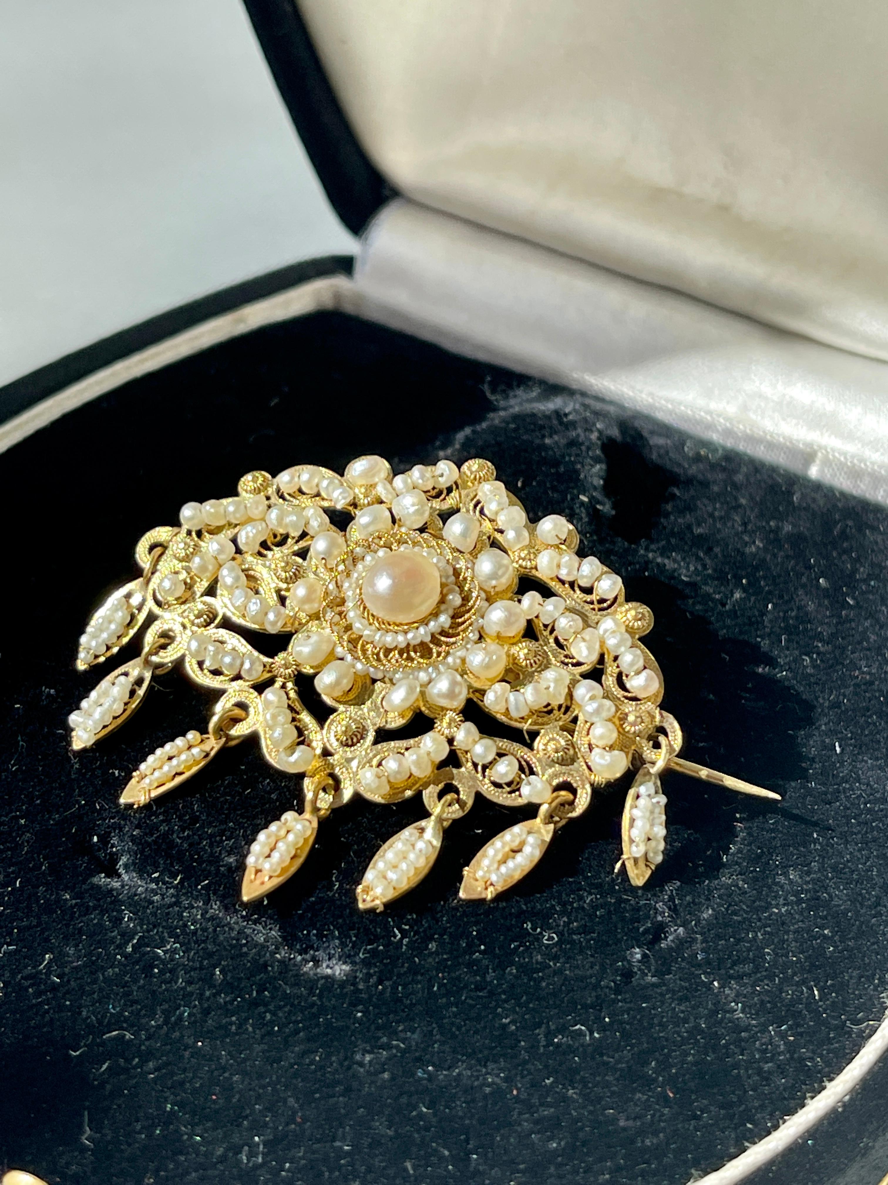 A Incredibly fine Spanish (Cordoba Region) Brooch in fine filigree work with natural seed pearls sewed with fine gold string.

The handmade craftsmanship on both the filigree as well as the sewing go the pearls is of some of the best we have seen in