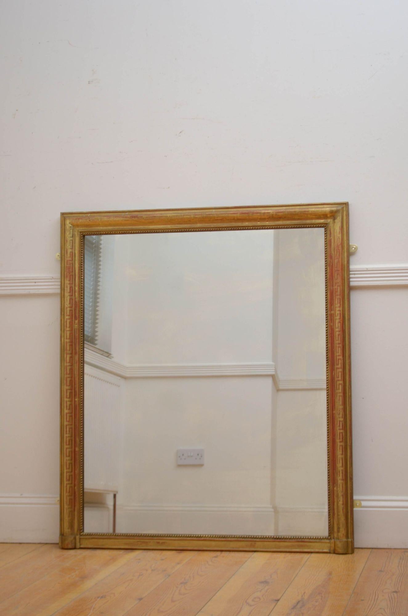 Sn5538 Elegant 19th century French, giltwood wall mirror, having original glass with some imperfections in beaded, moulded and gilded frame with Greek key decoration throughout. This antique mirror retains its original glass, original gilt, and