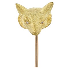 A yellow gold and diamond fox-head stick pin