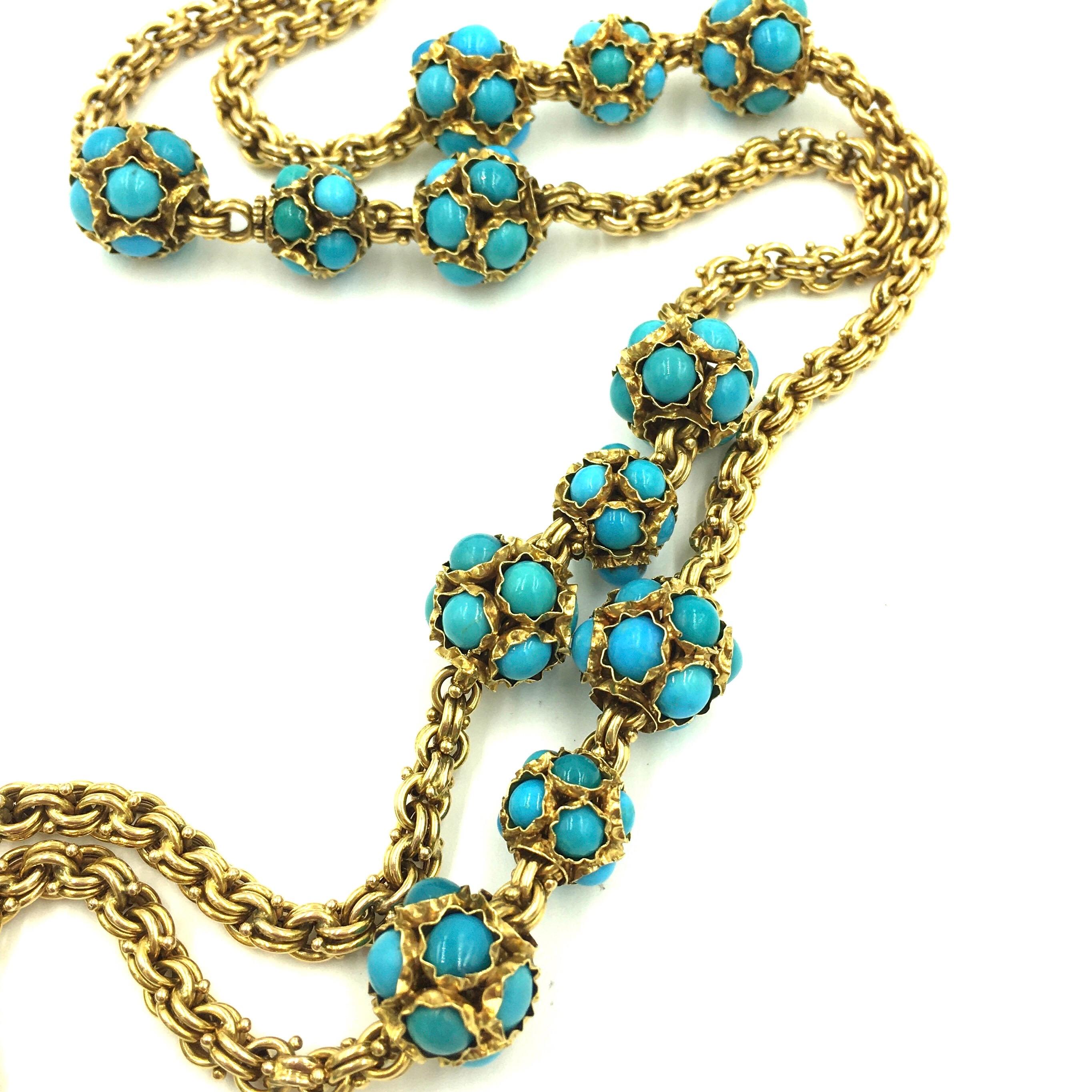 An 18 karat yellow gold and turquoise necklace. Circa 1960. Designed as a fancy link link chain, spaced at intervals by cabochon turquoise set boules. Length is approximately 38 inches, gross weight is approximately 155.8 grams. 
