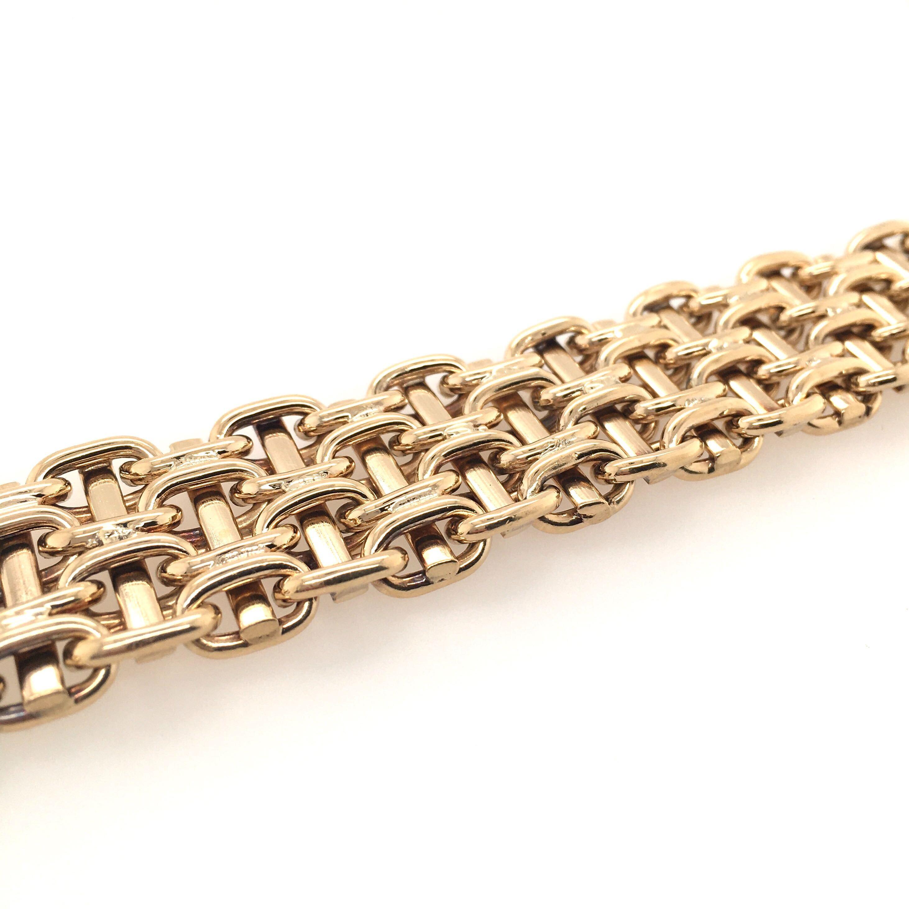 A 14 karat yellow gold bracelet.  The fancy mesh link bracelet measures scant 5/8 inch wide.  Length is approximately 7 inches, gross weight is approximately 59.1 grams. 
