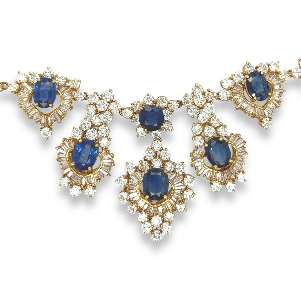An 18 karat yellow gold, sapphire and diamond necklace.  Designed as a line of round brilliant cut diamonds punctuated with pairs of round brilliant cut diamonds set at the front with nine (9) oval faceted sapphires measuring between approximately
