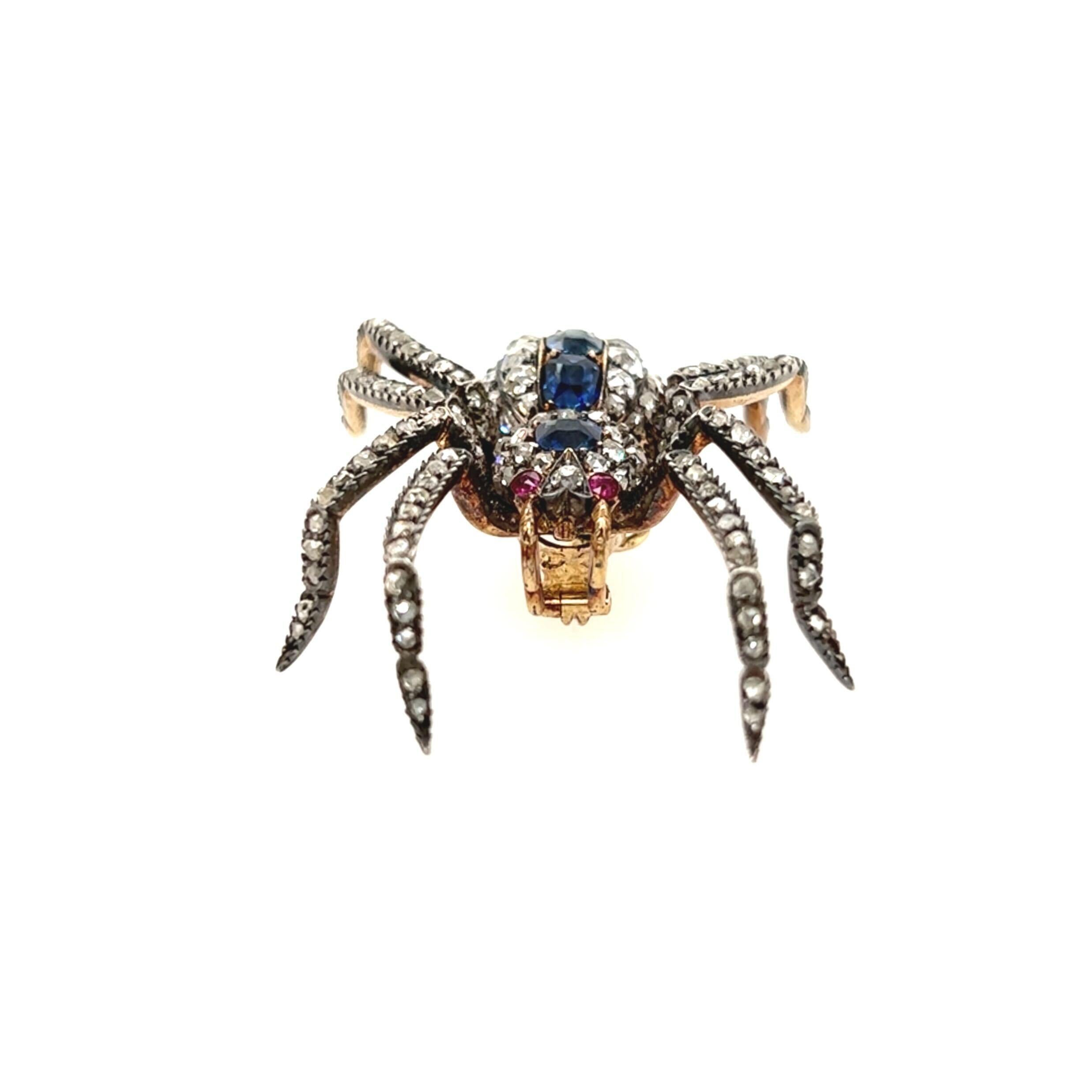 An 18 karat yellow gold, silver topped gold, diamond, sapphire and ruby brooch, 19th Century.  Fashioned as a spider set on the legs and body with approximately one hundred sixty three  rose cut and old mine cut diamonds of various sizes, the body
