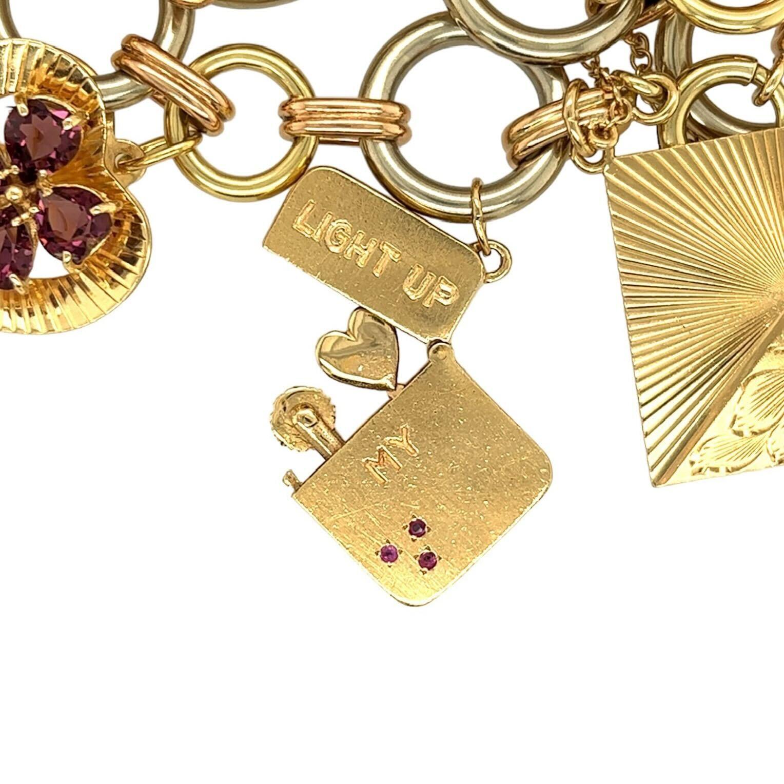 A 14 karat yellow, white and rose gold, pearl, ruby, sapphire, and amethyst bracelet.  The charm bracelet designed on a tri color gold ring and bar bracelet, suspending seven (7) charms consisting of:  a grand piano with a pierced case filled with