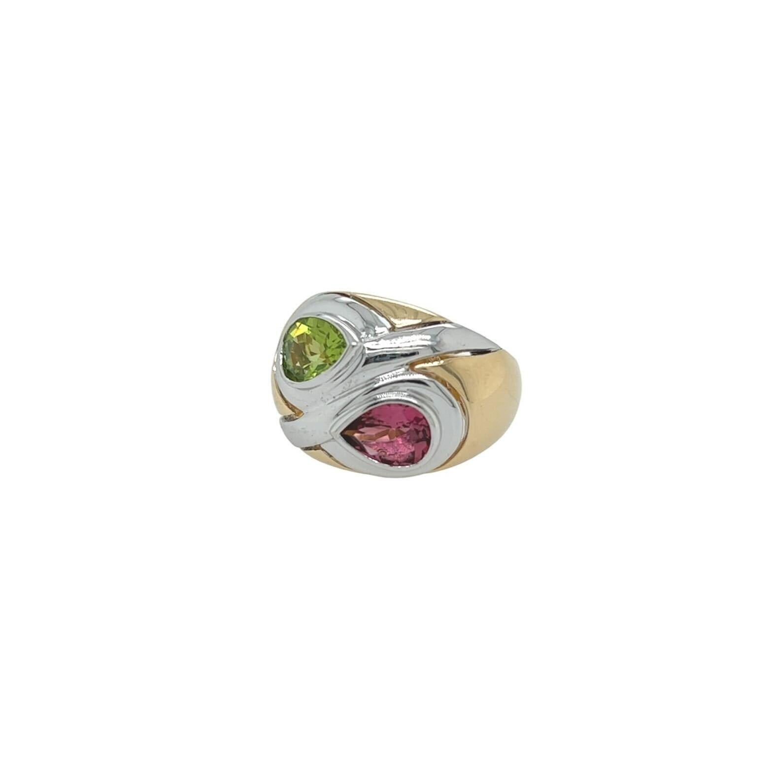 A 14 karat yellow and white gold, peridot and pink tourmaline ring.  The ring centering a bezel set pear shaped peridot measuring approximately 7.73 x 5.69 mm and a bezel set pear shaped pink tourmaline measuring approximately 7.26 x 5.54 mm